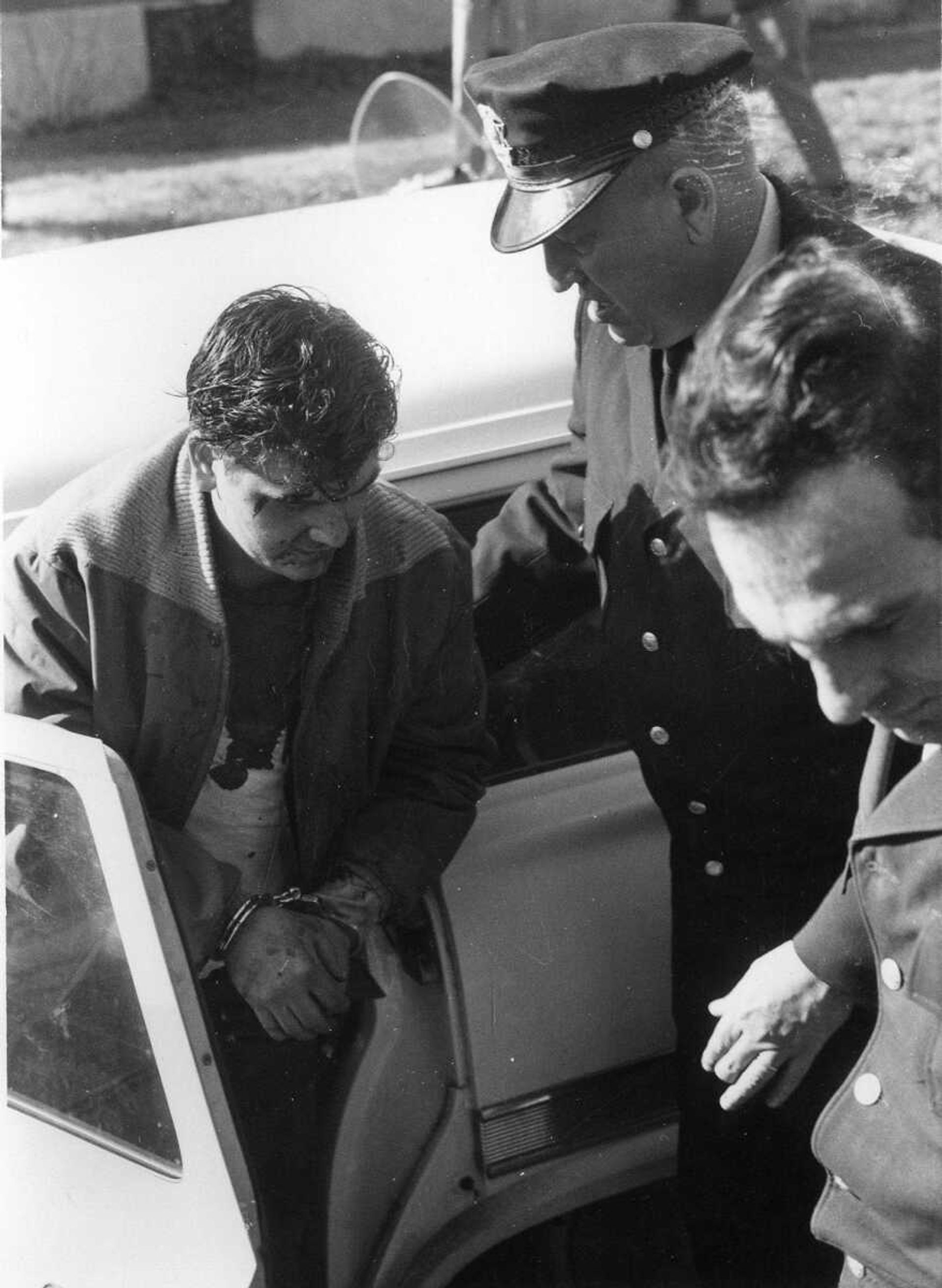 Sammy Aire Tucker exiting an automobile, having been caught near Grassy, Mo., the day after the shootout with Cape Girardeau police officers. March 11, 1961. (Photo not published; photo by Don Kremer Studio)