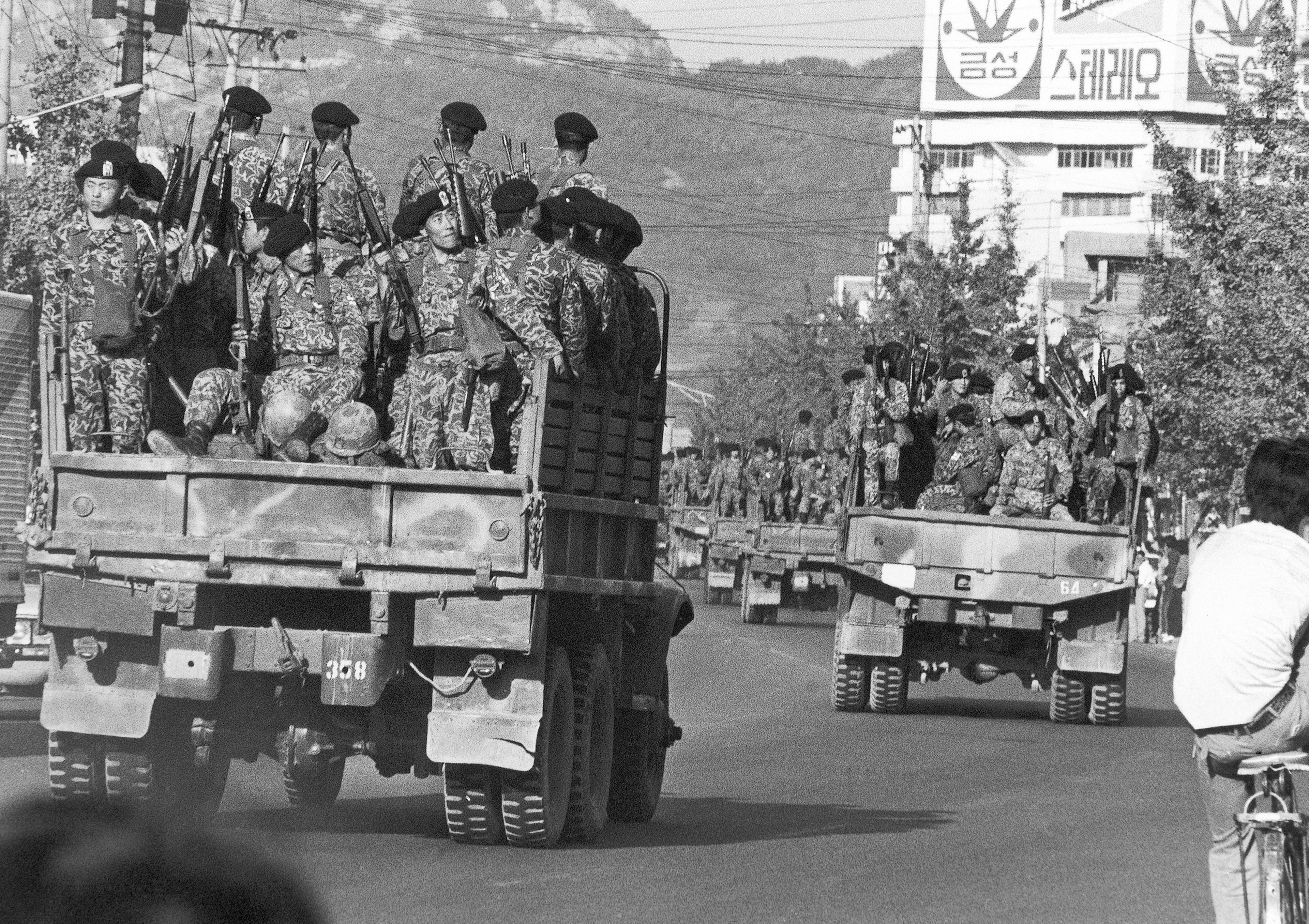 FILE- Truckloads of South Korean paratroopers move in downtown Masan on Oct. 20, 1979 as a "garrison decree" was proclaimed following two days of rioting against the government in this south coast city, 300 km south of Seoul, South Korea. (AP Photo/Kim Chon-Kil, File)