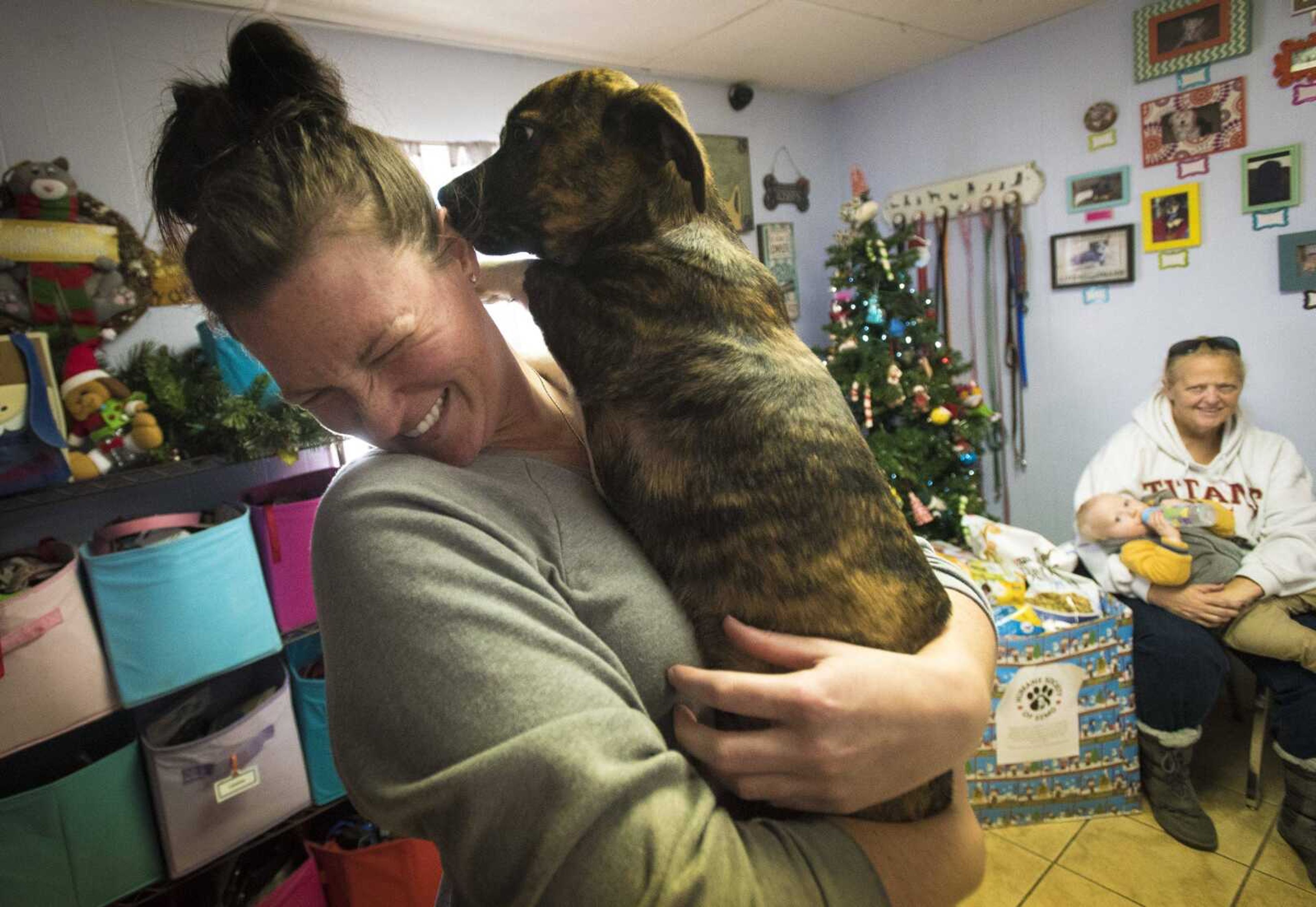 Jessie Daniels gets a kiss from Reese the dog at the 40th anniversary of the Humane Society of Southeast Missouri Saturday, Dec. 16 , 2017 in Cape Girardeau.