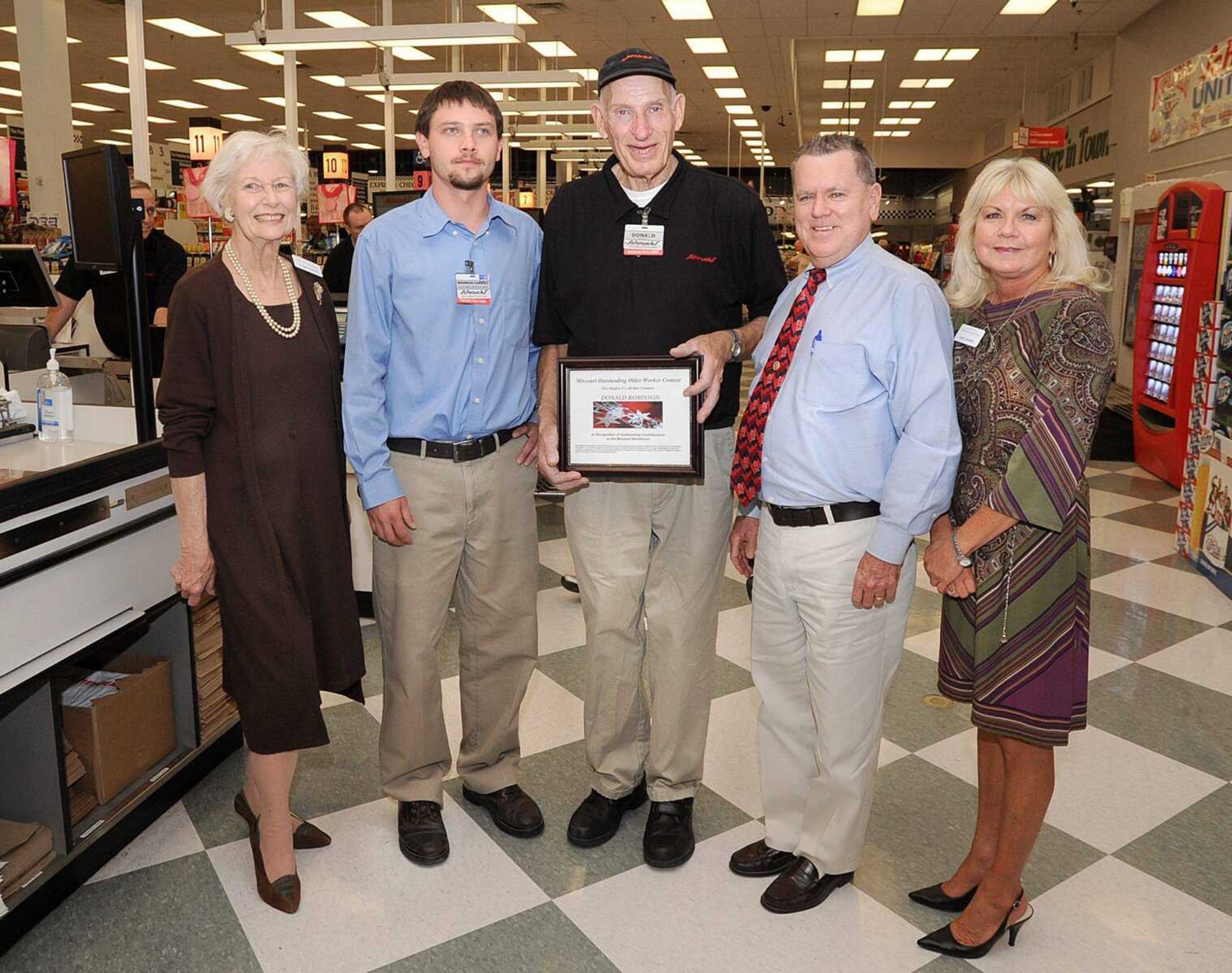 From left, Jo Ann Roberts, Brandon Carroll, Bob Mott and Julie Allison present Donald Robinson, center, with the Missouri Older Worker of the Year award Tuesday at Scnhuck's in Cape Girardeau. (Laura Simon)