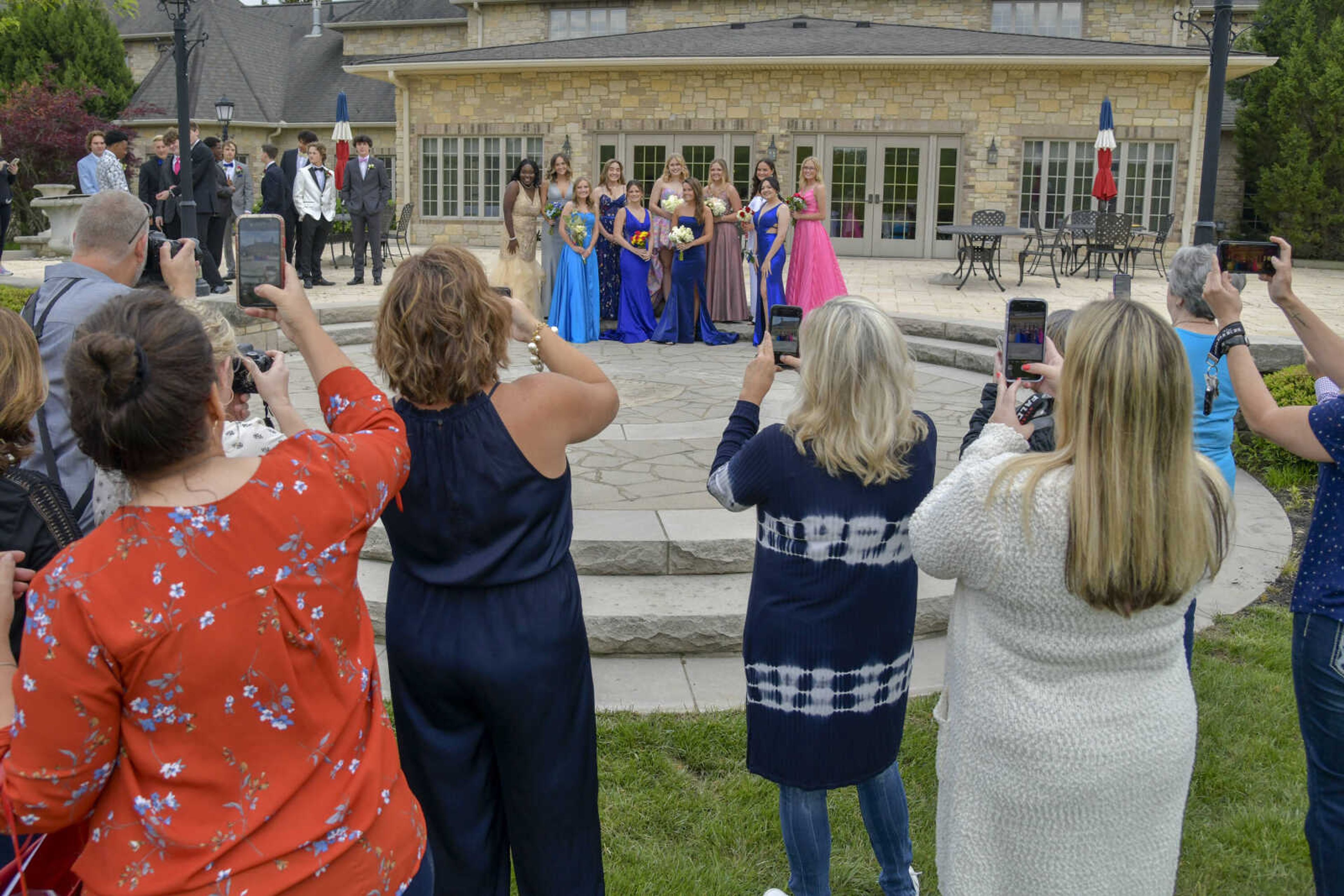 Parents and loved ones take pictures of posed students in their prom outfits during a pre-prom event at the Dalhousie Golf Club in Cape Girardeau on Saturday, May 8, 2021.