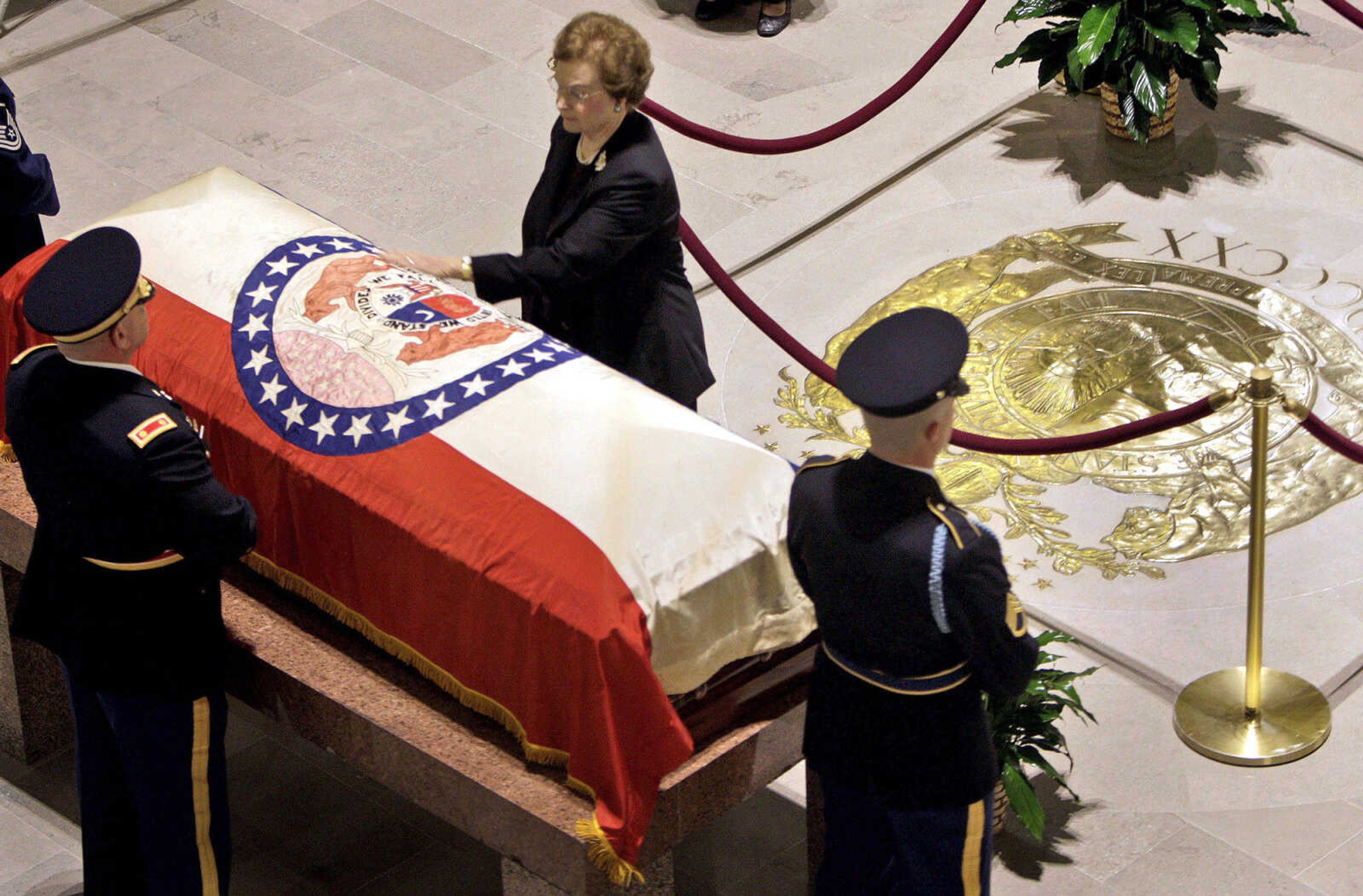 Betty Hearnes places her hand on the casket of her husband, former Gov. Warren Hearnes before the start of a public viewing in the Missouri Capitol Rotunda Wednesday, Aug. 19, 2009, in Jefferson City, Mo. Hearnes, who from 1965 to 1973 was the first Missouri governor to serve two full consecutive terms in office, died late Sunday night at the age of 86 at his home in Charleston.(AP Photo/Jeff Roberson)