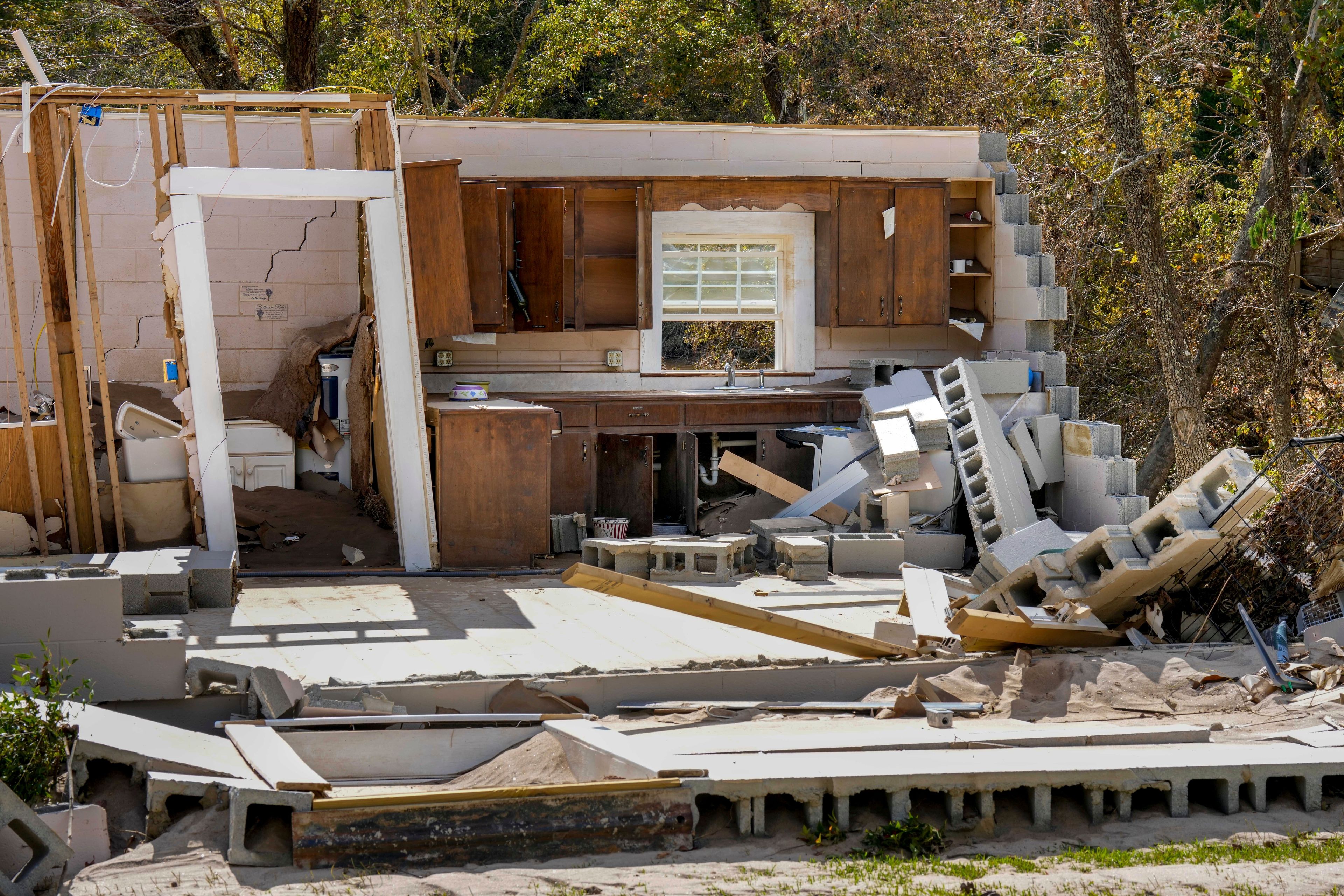 Damaged to one of the White family's homes that was destroyed by Hurricane Helene is seen, Tuesday, Oct. 1, 2024 in Morganton, N.C. The adjacent Catawba River flooded due to torrential rains destroying seven of the family's nine homes on the property. (AP Photo/Kathy Kmonicek)