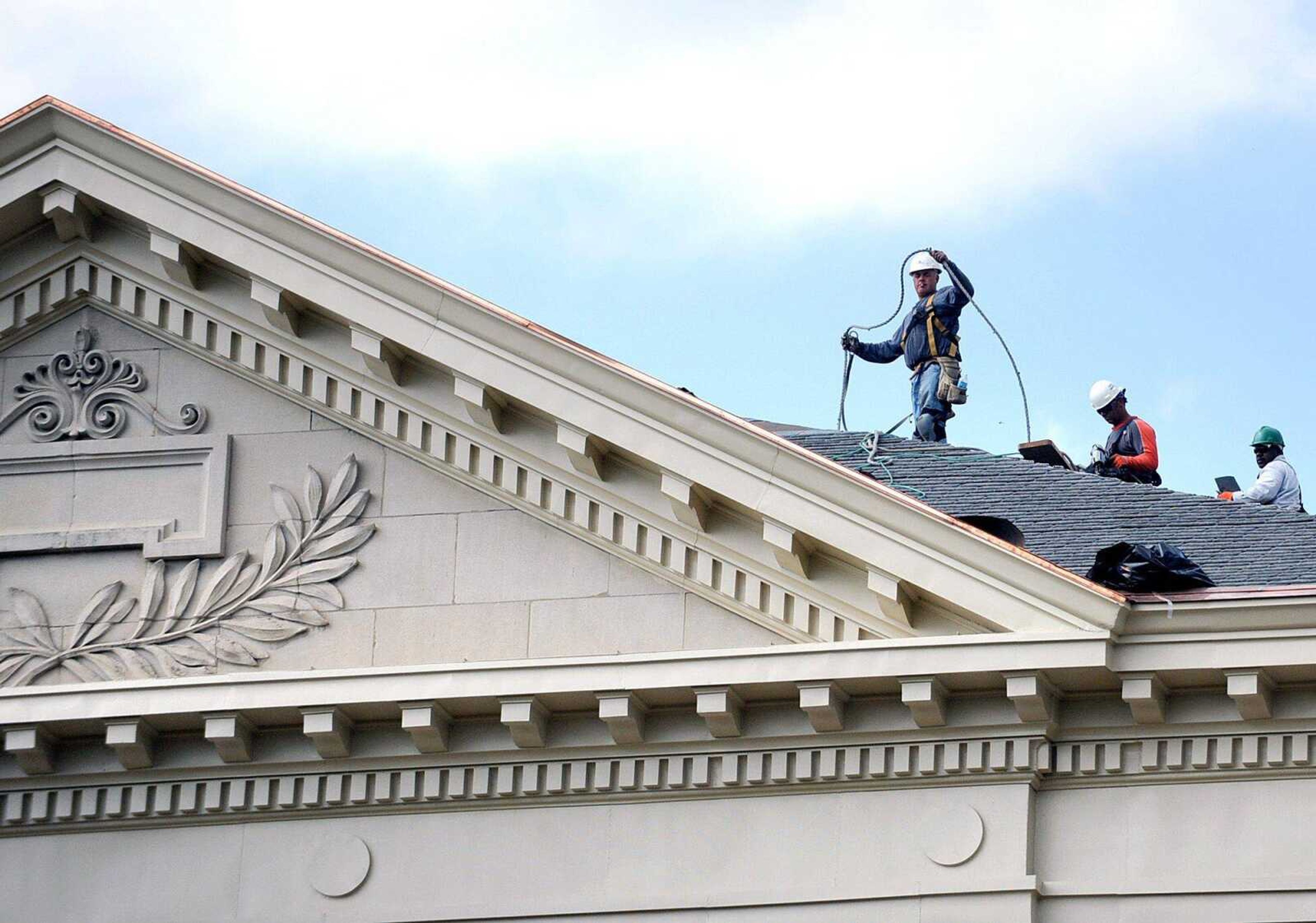 Workers work on replacing the roof of Academic Hall on the campus of Southeast Missouri State University Wednesday, May 16, 2012 in Cape Girardeau. The building is receiving a new roof, new copper dome, and they are upgrading the offices and infrastructure. Completion of the renovations is expected to be summer of 2013. (Laura Simon)