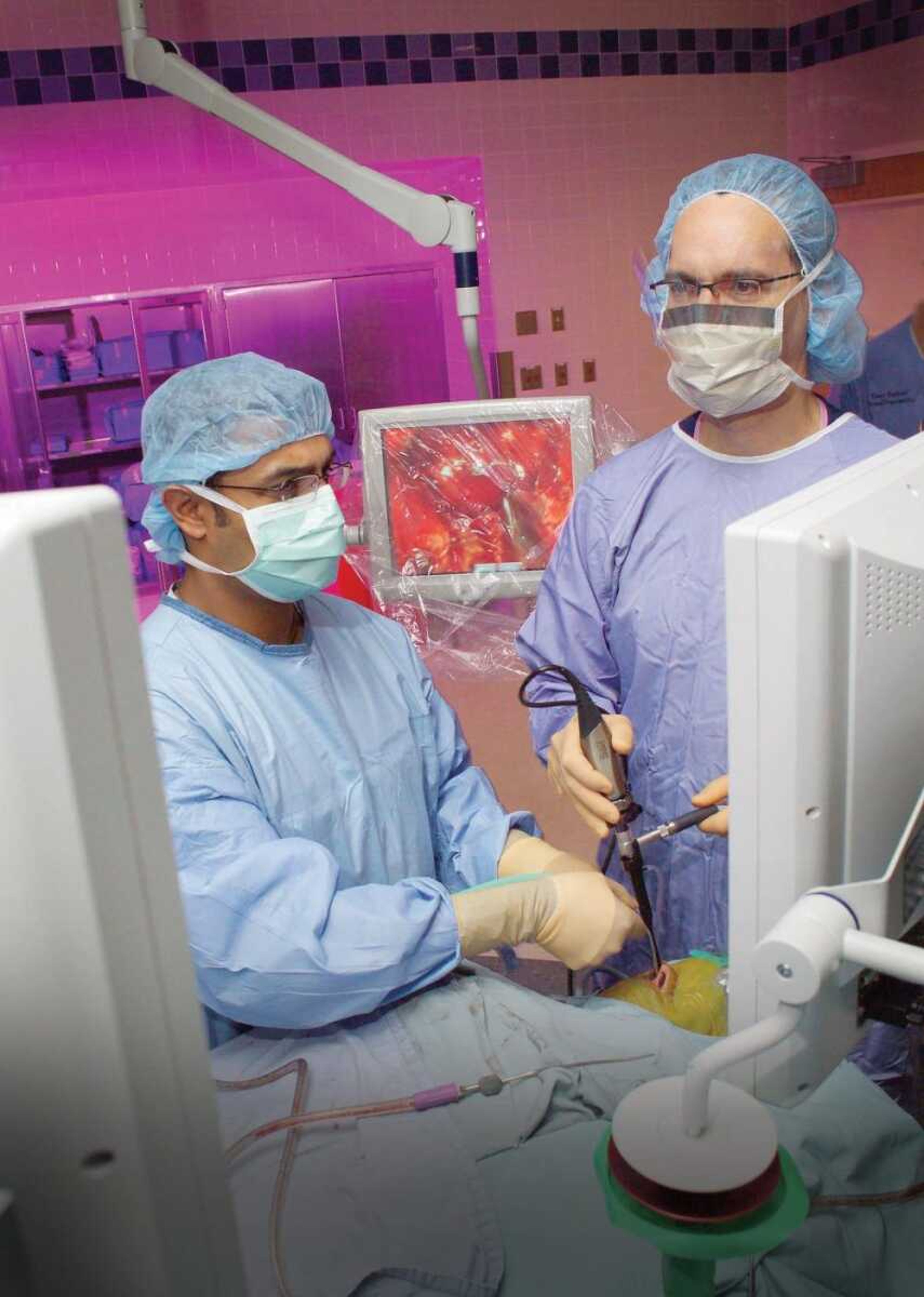 Dr. Carl Snyderman, right, used an endoscope to view the patient's brain while Dr. Amin Kassam removed a brain tumor through the nose, using special instruments designed for this surgery at University of Pittsburgh Medical Center in September 2006. (University of Pittsburgh Medical Center)