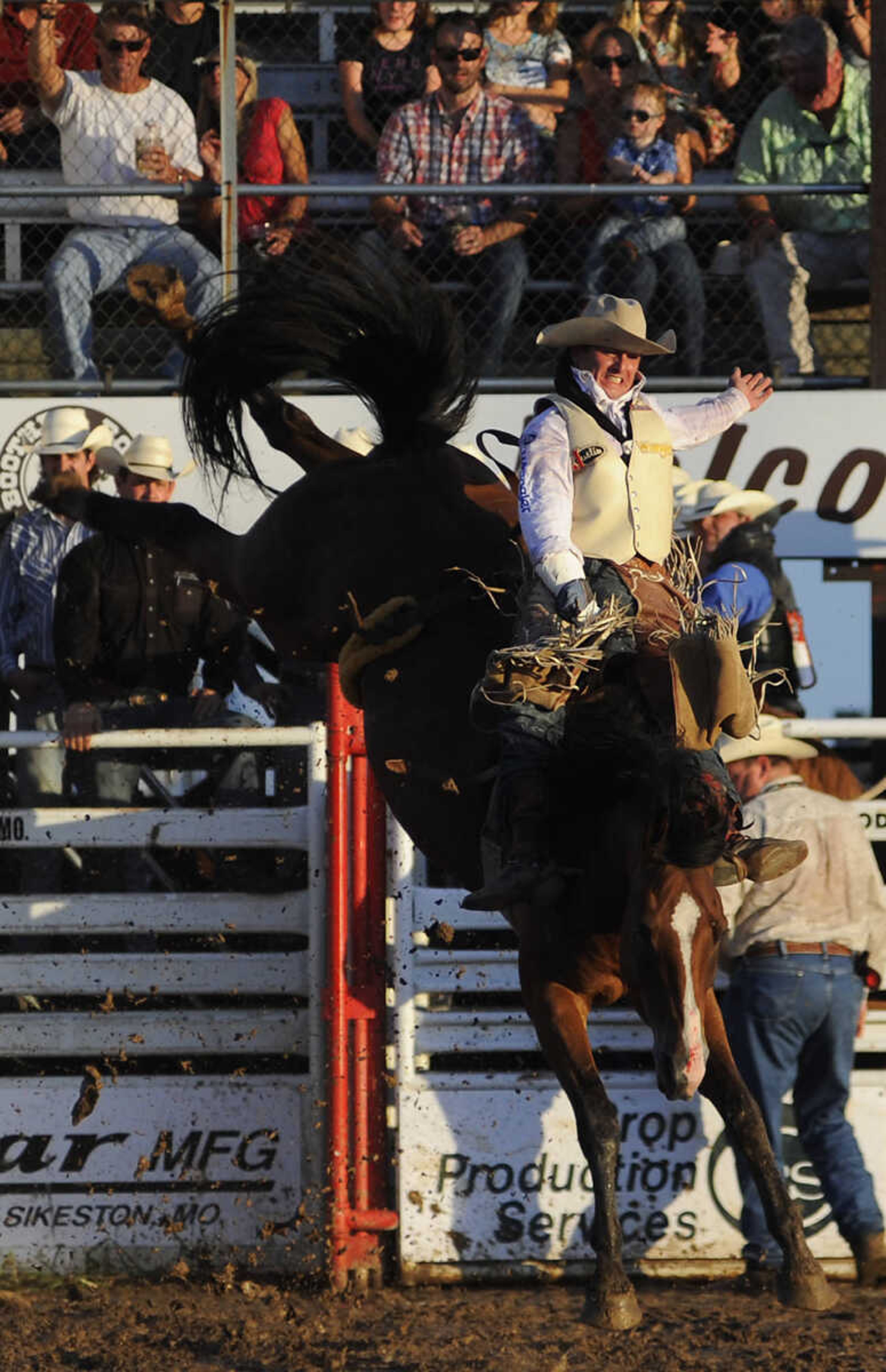 Ryan Gray rides Ankle Biter in the bareback riding competition at the Sikeston Jaycee Bootheel Rodeo Wednesday, August 7, in Sikeston, Mo. Gray received a score of 86 for his ride.