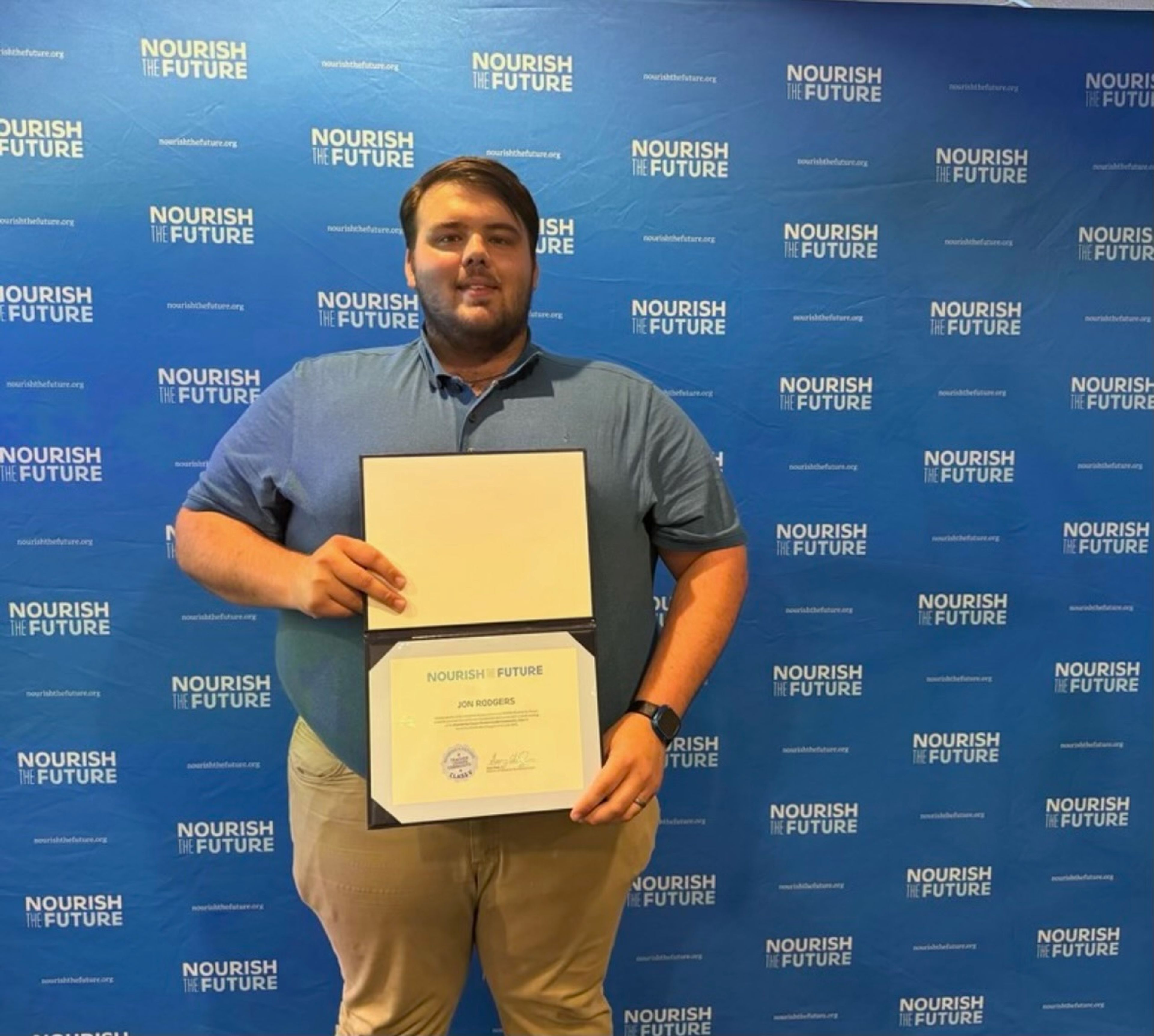 Jon Rodgers holds his completion certificate from the Nourish the Future program. 