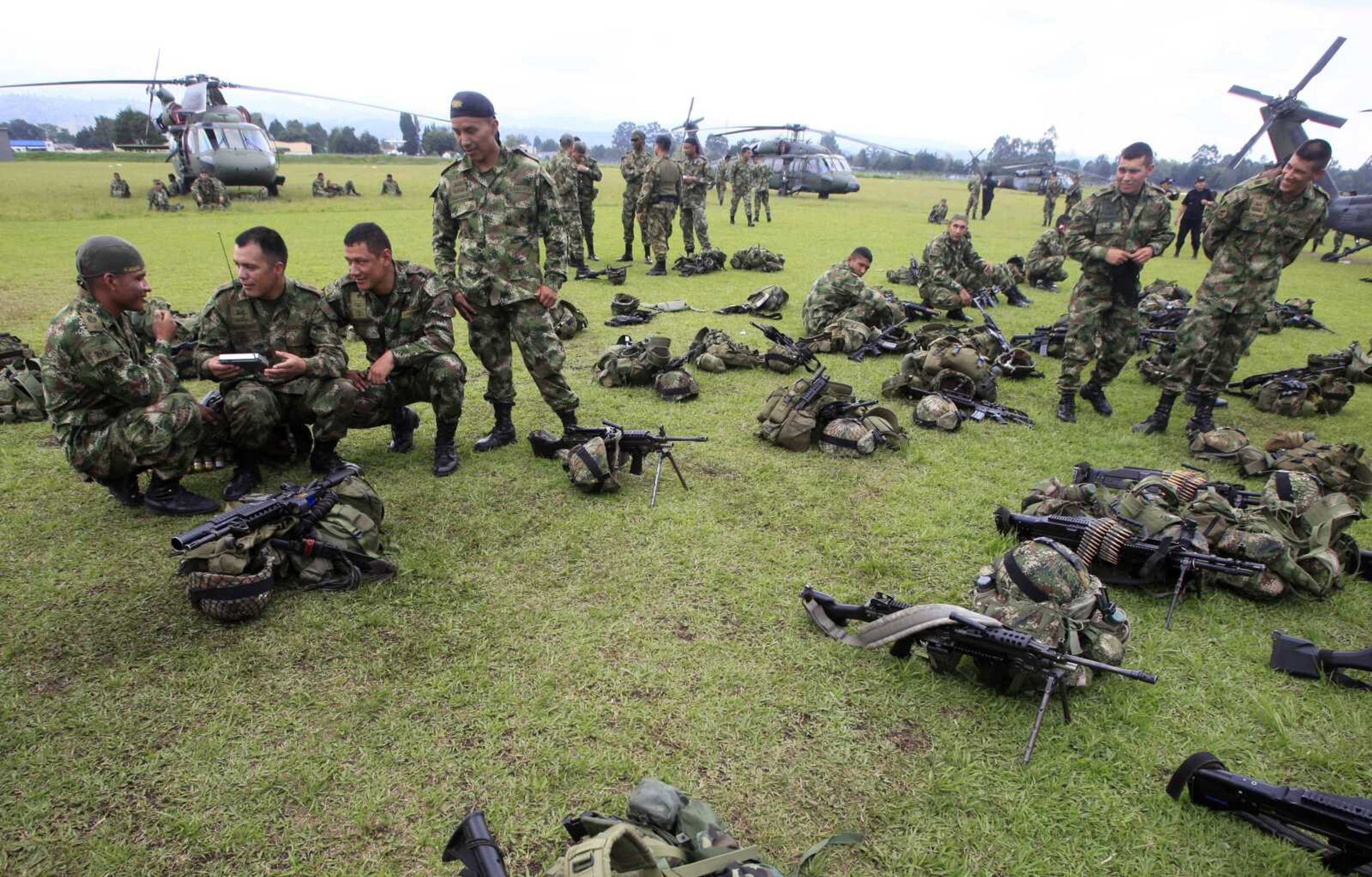 Soldiers that took part in the operation that lead to the death of Alfonso Cano, 63, the top leader of the Revolutionary Armed Forces of Colombia, rest on a field Saturday at the military base in Popayan, Colombia. Cano was killed in a military raid in a remote area of the southwestern state of Cauca. (Fernando Vergara ~ Associated Press)