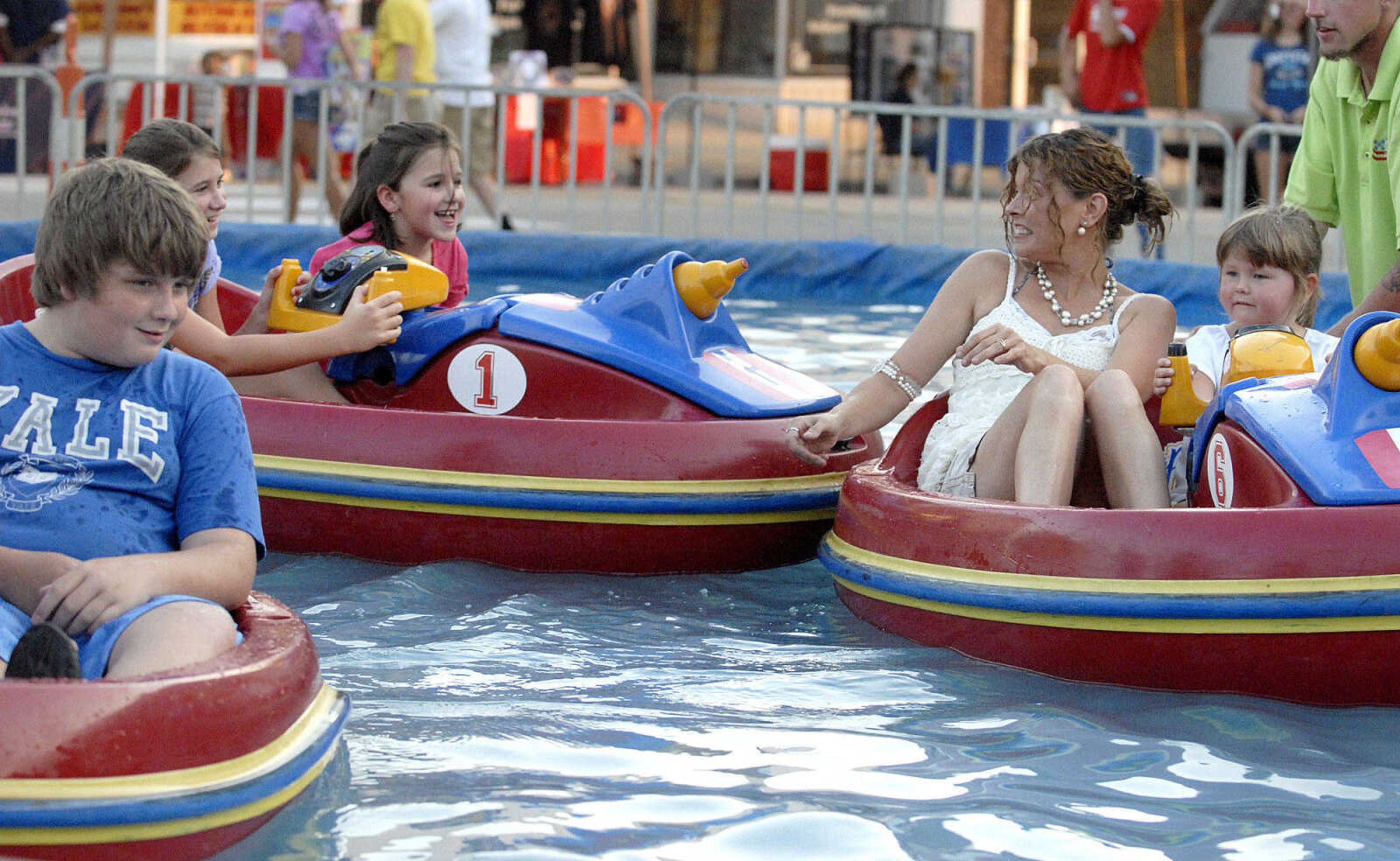 LAURA SIMON ~ lsimon@semissourian.com
From left: Steven Adams, Brianna and Kaitlynn Fouts, Jackie Adams and Shandi Rogers make a splash on the bumper boats Tuesday, July 26, 2011 during the 103rd annual Jackson Homecomers celebration.