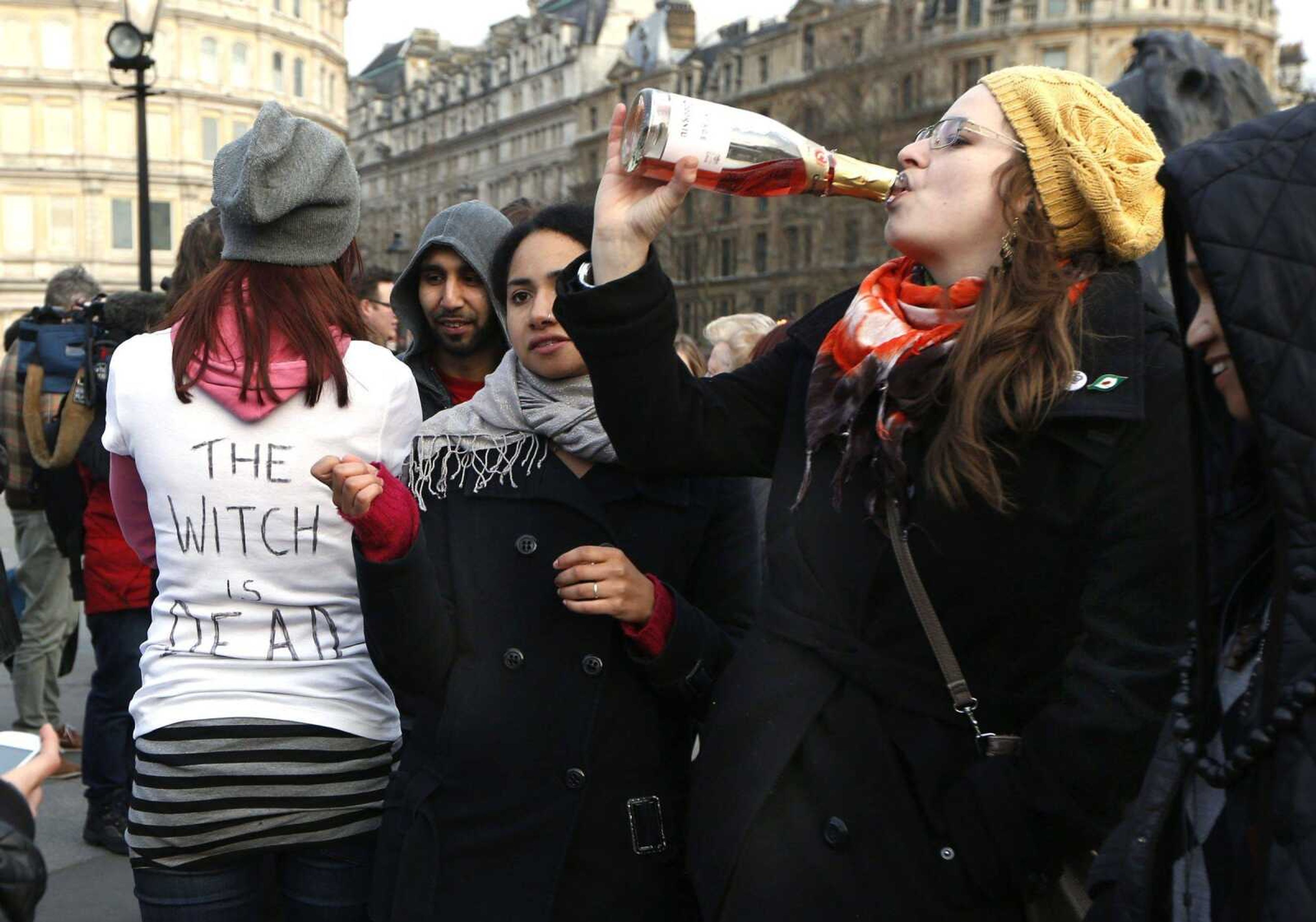 Anti-Margaret Thatcher protesters react to the death of the former British prime minister as they gather at Trafalgar Square on Monday in London. &#8220;The Witch is Dead&#8221; on the T-shirt refers to an anti-Thatcher song. (Sang Tan ~ Associated Press)