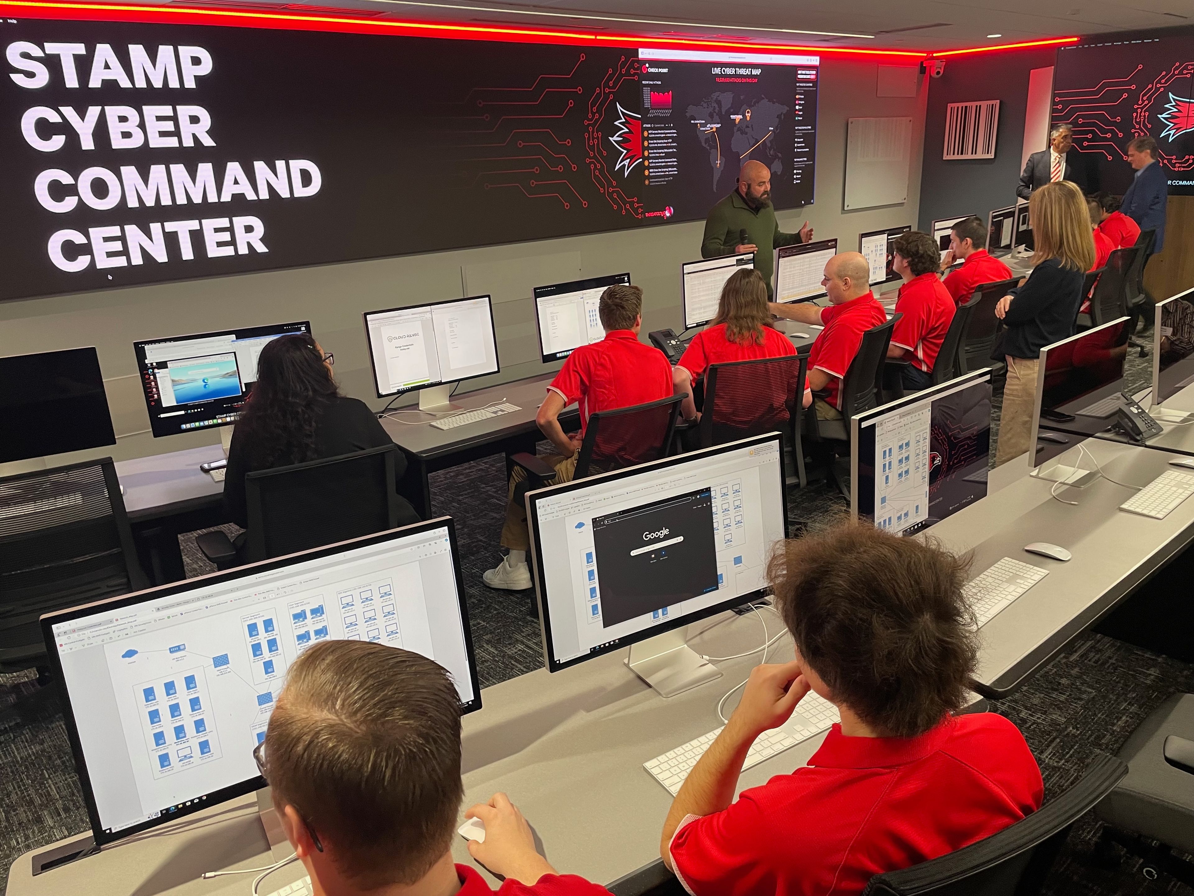 IBM's Marcus Linder, the cloud range attack master, briefs the SEMO student cyber defense team before they begin countering a simulated threat.