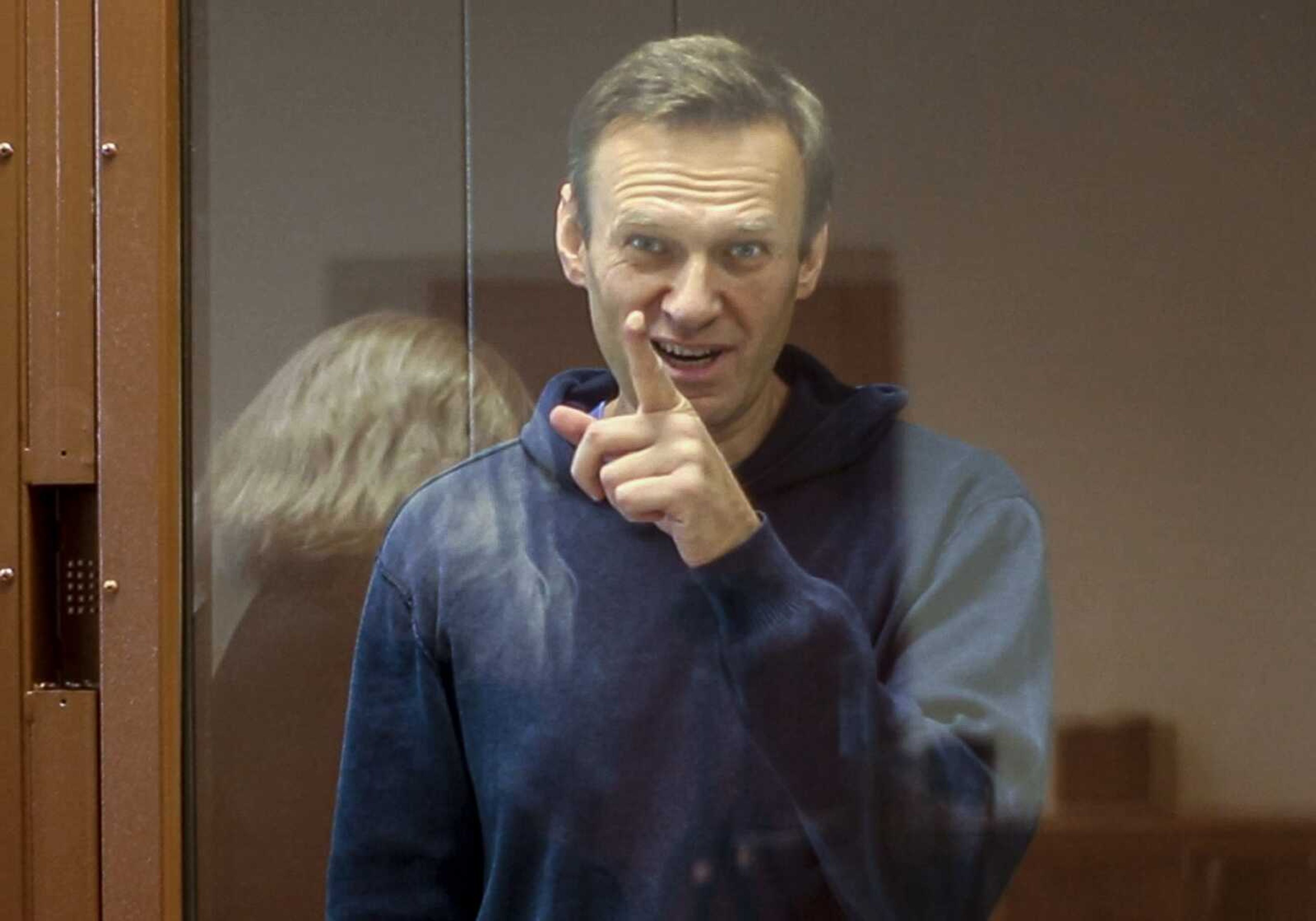 In this photo, taken from footage provided by the district court, Russian opposition leader Alexei Navalny gestures during a court hearing Feb. 16 in Moscow.