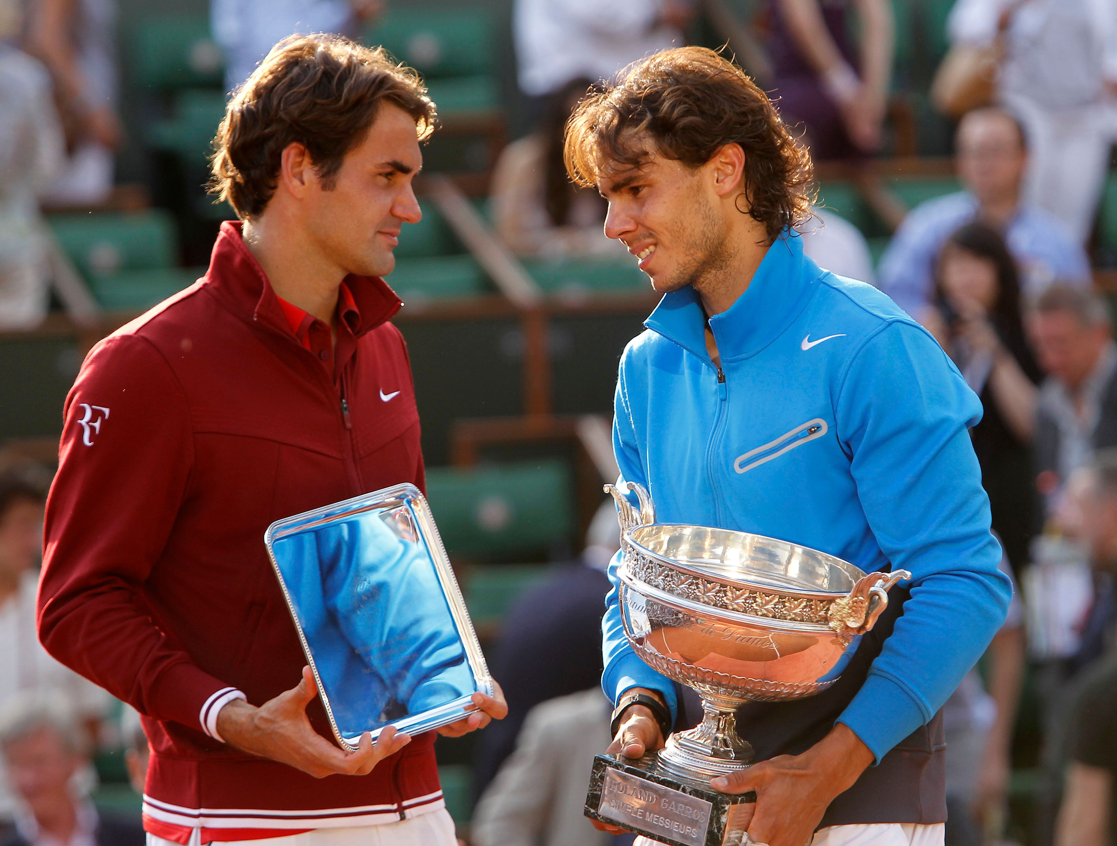 FILE - Spain's Rafael Nadal, right, and Switzerland's Roger Federer pose with their trophies after the men's final match for the French Open tennis tournament at Roland Garros stadium in Paris, June 5, 2011, as Nadal has announced he will retire from tennis at age 38 following the Davis Cup finals in November. (AP Photo/Lionel Cironneau, File)