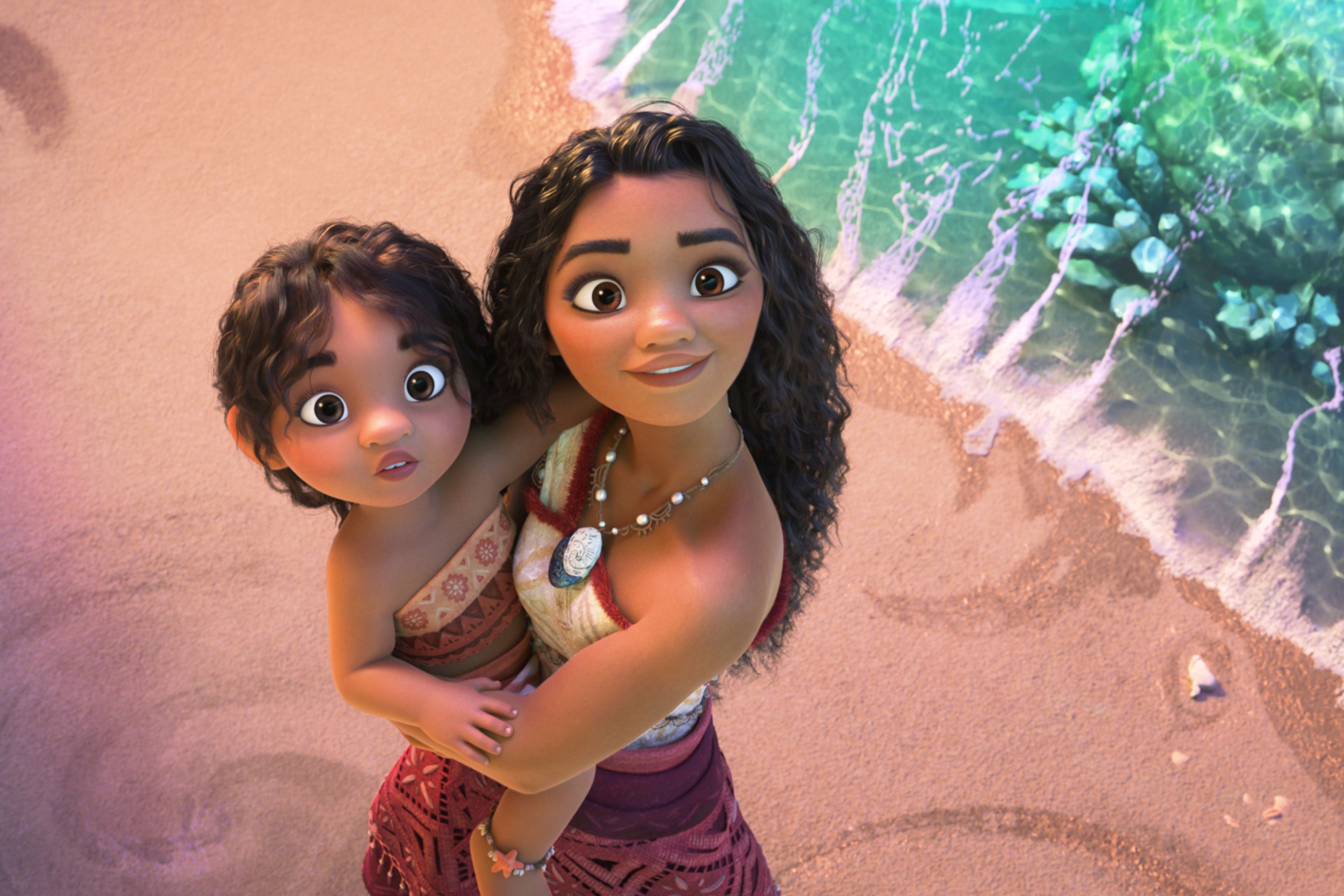 This image released by Disney shows the characters Moana, voiced by Auli'i Cravalho, holding Simea, voiced by Khaleesi Lambert-Tsuda, in a scene from "Moana 2." (Disney via AP)