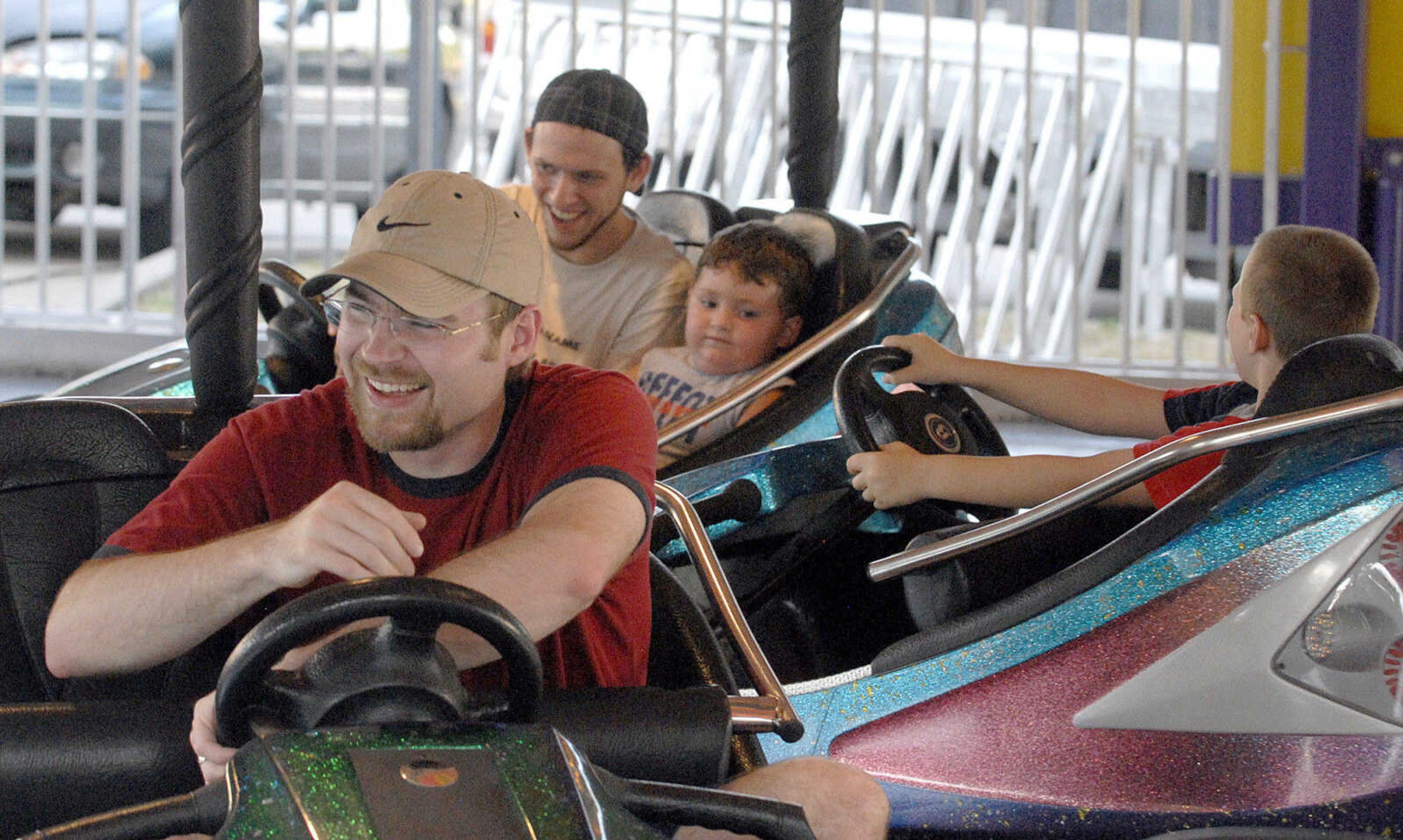 LAURA SIMON ~ lsimon@semissourian.com
Jon Fox, front, and Matt, left, and Leo Cartwright bump around on the bumper cars Tuesday, July 26, 2011 during the 103rd annual Jackson Homecomers celebration.