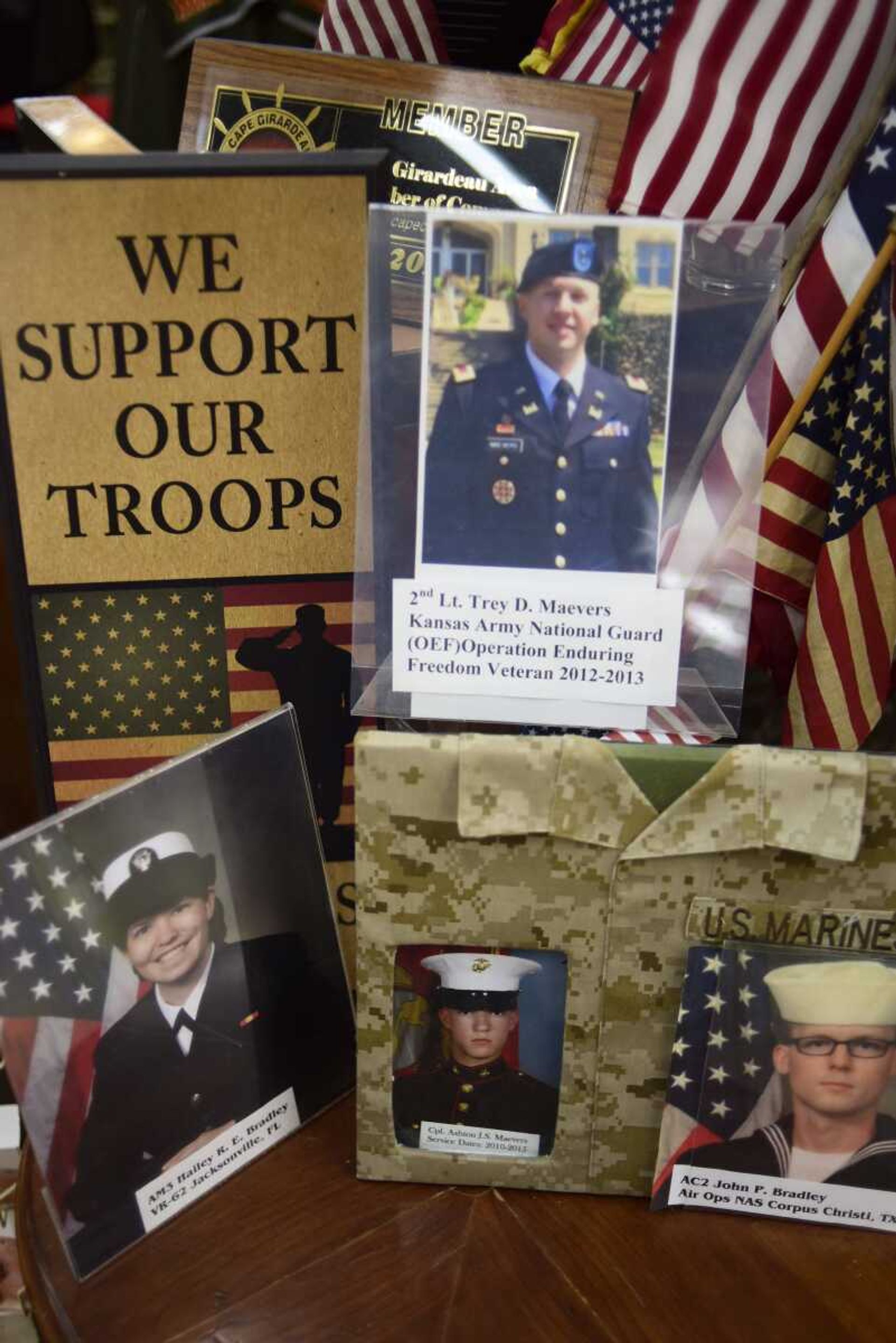 Photos of Deb Maevers  children who are serving in the military are shown at Pastimes Antiques Wednesday in Cape Girardeau.