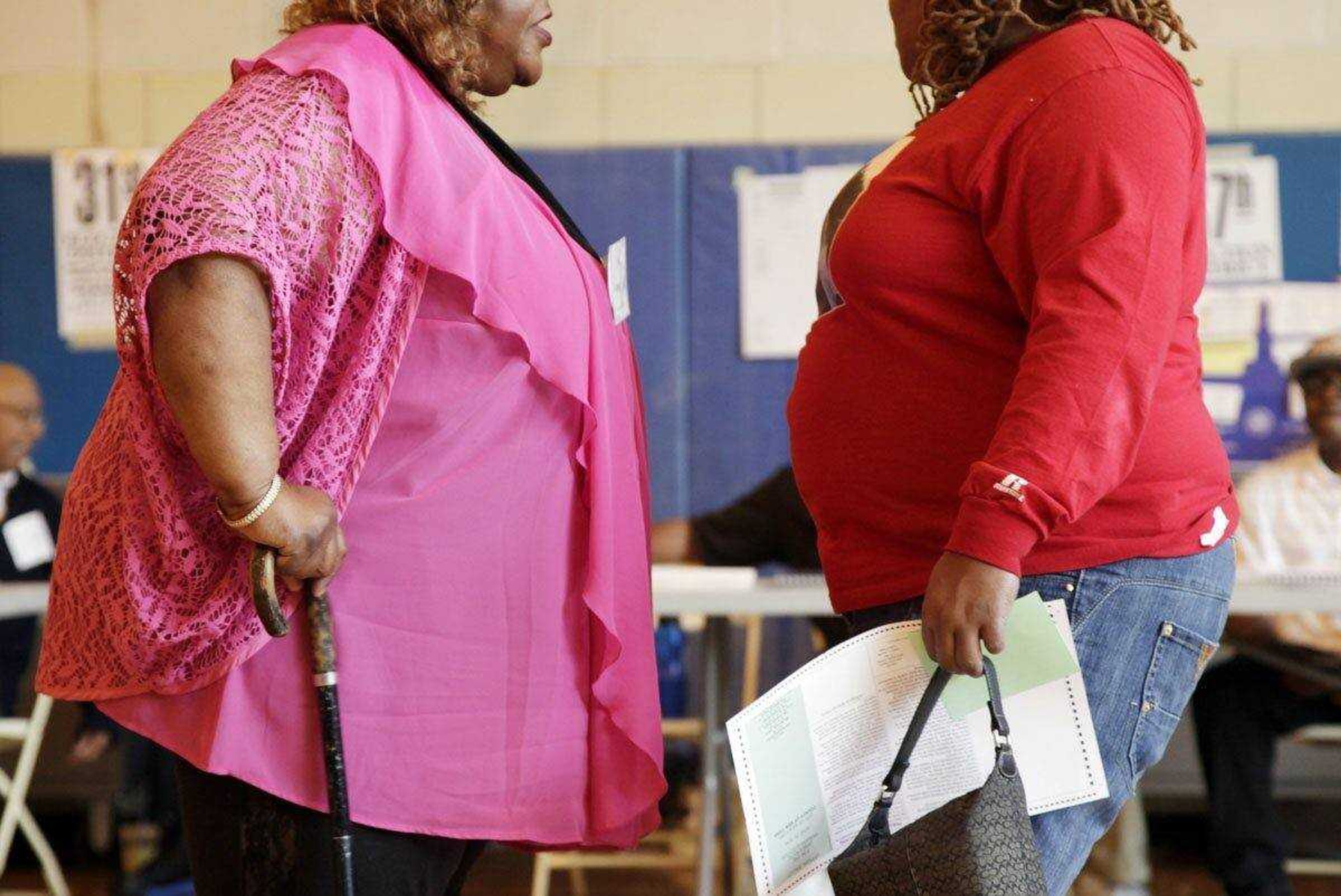 Two overweight women hold a conversation, Tuesday, June 26, 2012 in New York. Two-thirds of American adults are either overweight or obese and some 17 percent of children and teens are obese. (AP Photo/Mark Lennihan)