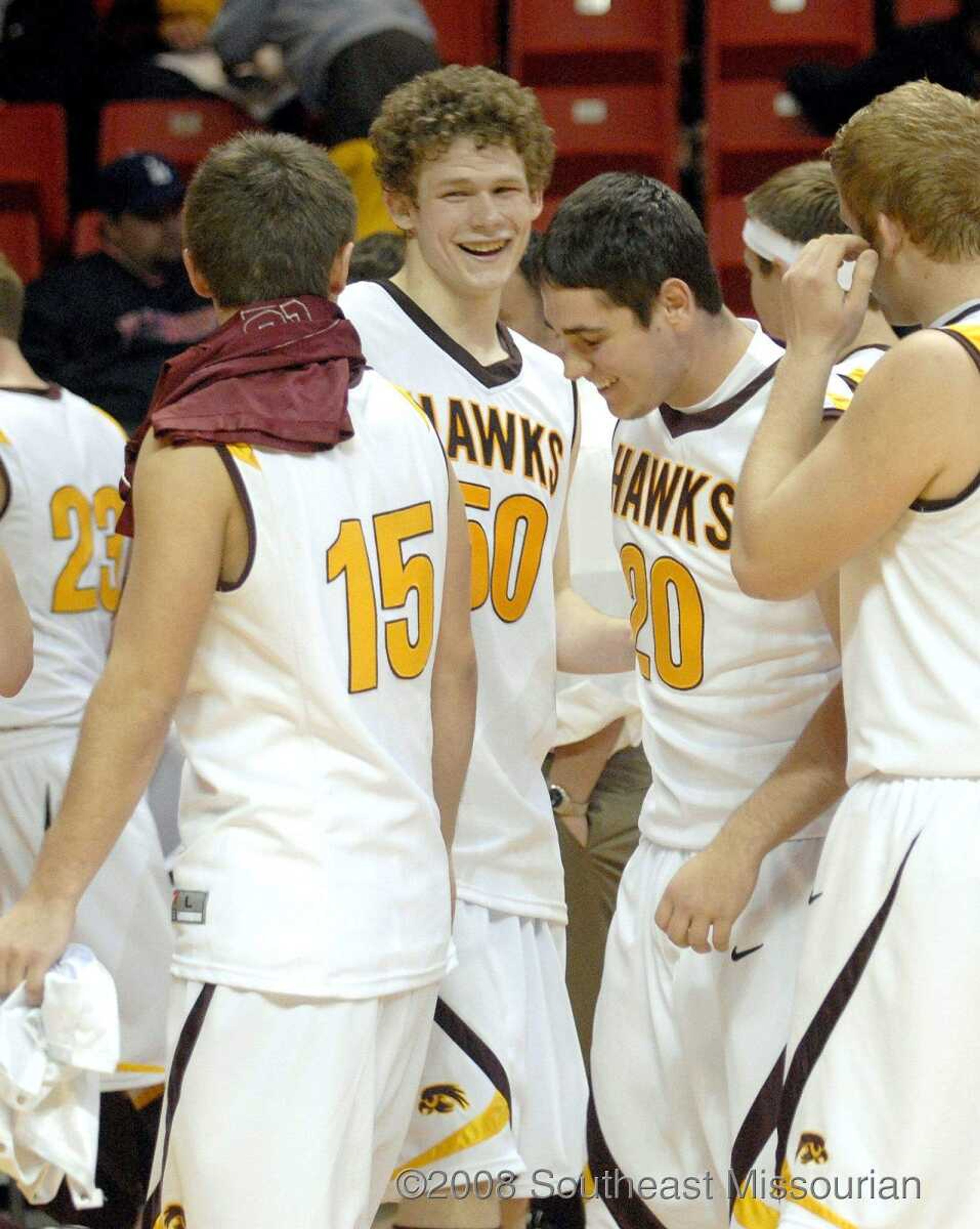 ELIZABETH DODD ~ edodd@semissourian.com
Kelly's Eric Turley, center, laughs with teammates after defeating Meadow Heights 78-61 in the Christmas Tournament Friday at the Show Me Center.