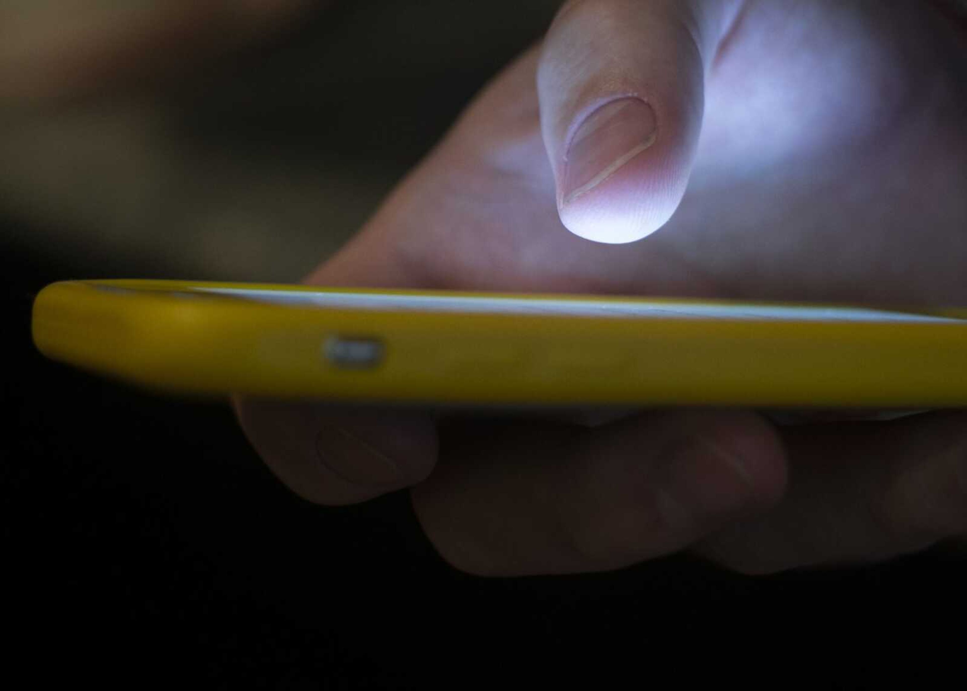 A man uses a cellphone Aug. 11, 2019, in New Orleans.