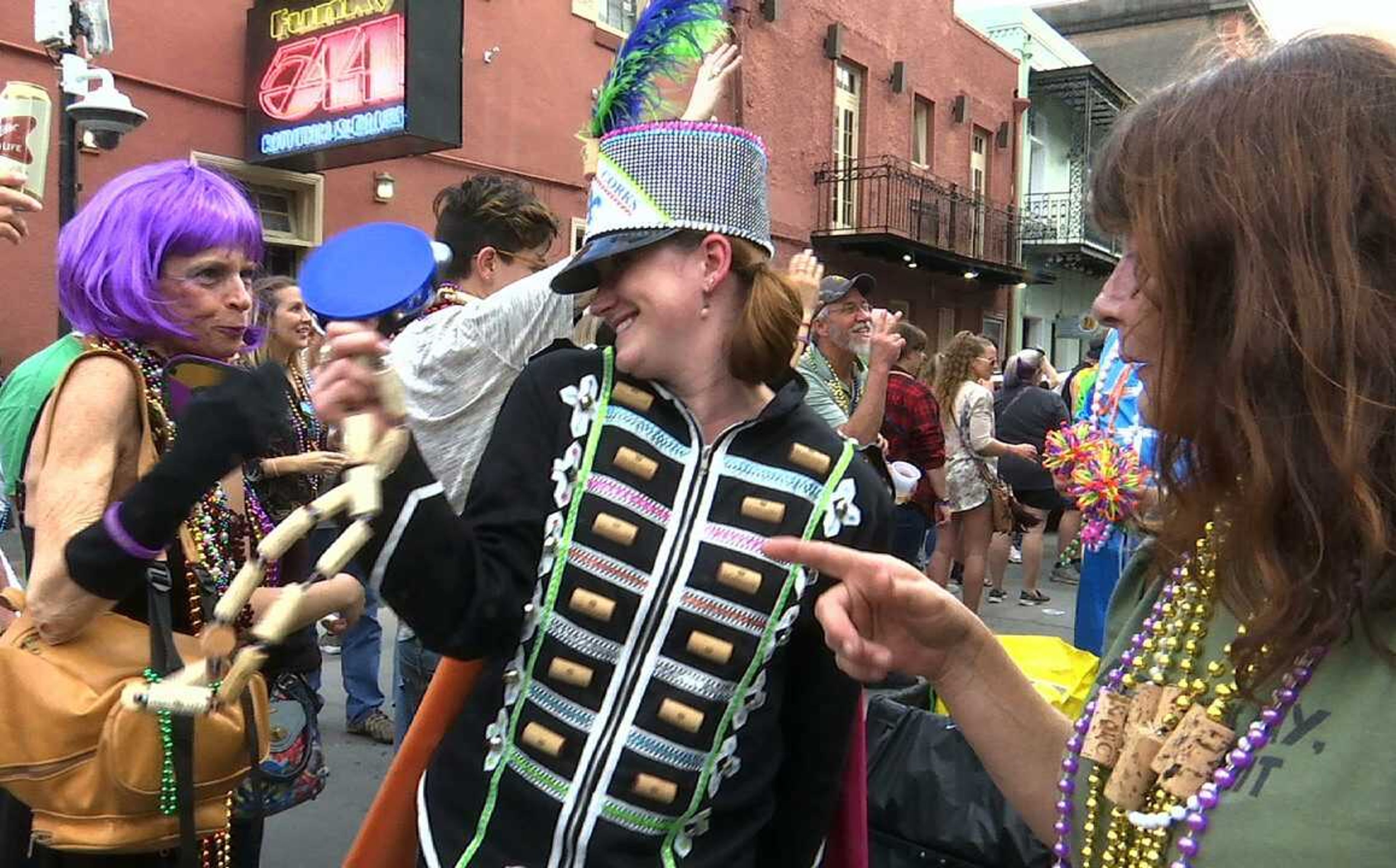 In this Feb. 22, image made from video, a woman wearing a marching band costume taunts revelers with trinkets and beads in the Krewe of Cork parade in New Orleans. New Orleans now boasts some 50 walking Carnival clubs that parade throughout the Mardi Gras season. That's the most ever in the city's long Carnival history, making Mardi Gras more colorful and diverse than ever before.