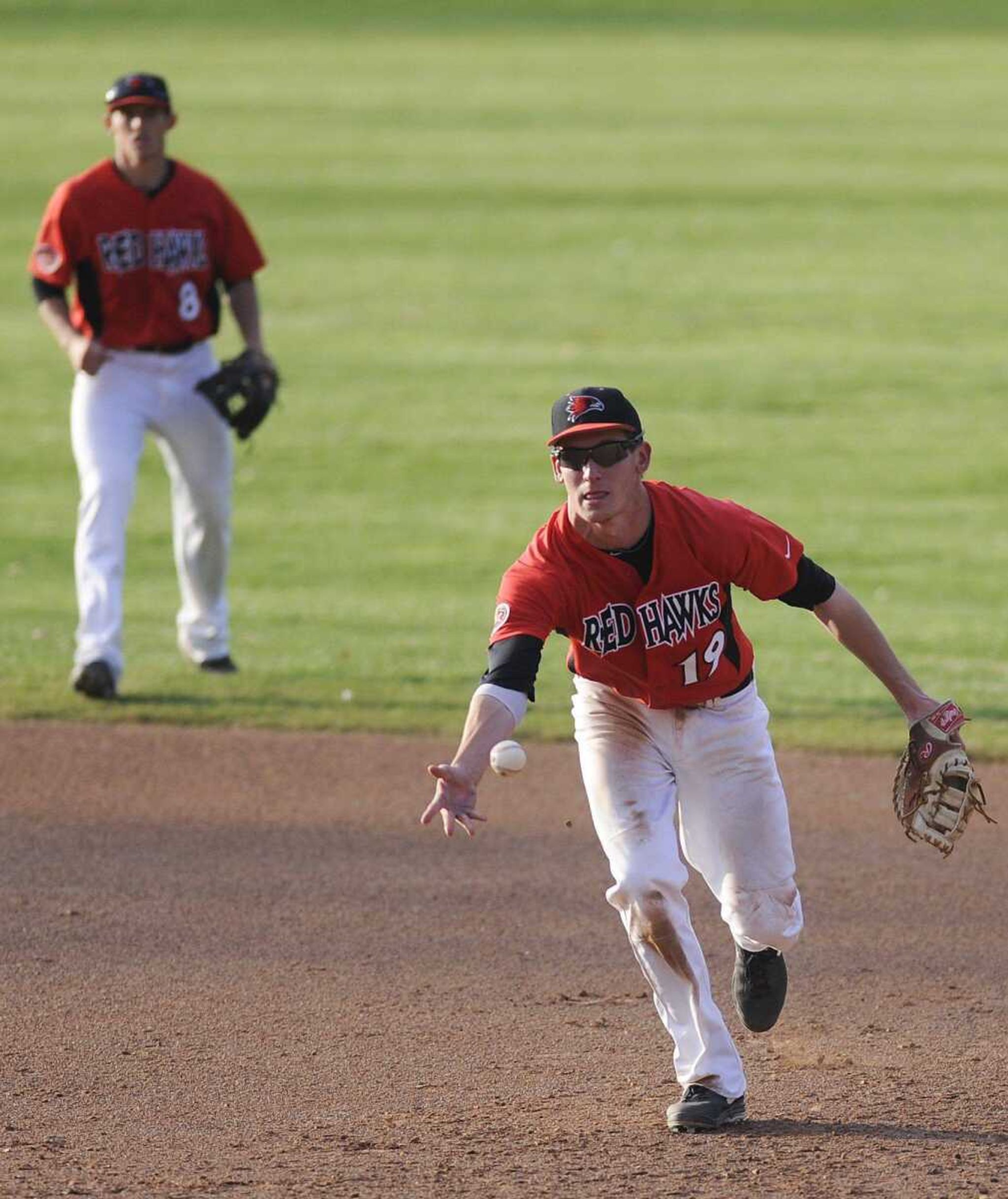 Southeast Missouri State first baseman Matt Tellor tosses the ball to pitcher Michael Patman to get Southern Illinois Carbondale's Wes Neece out during the Redhawks' loss to the Salukis Tuesday, April 9, at Capaha Stadium.