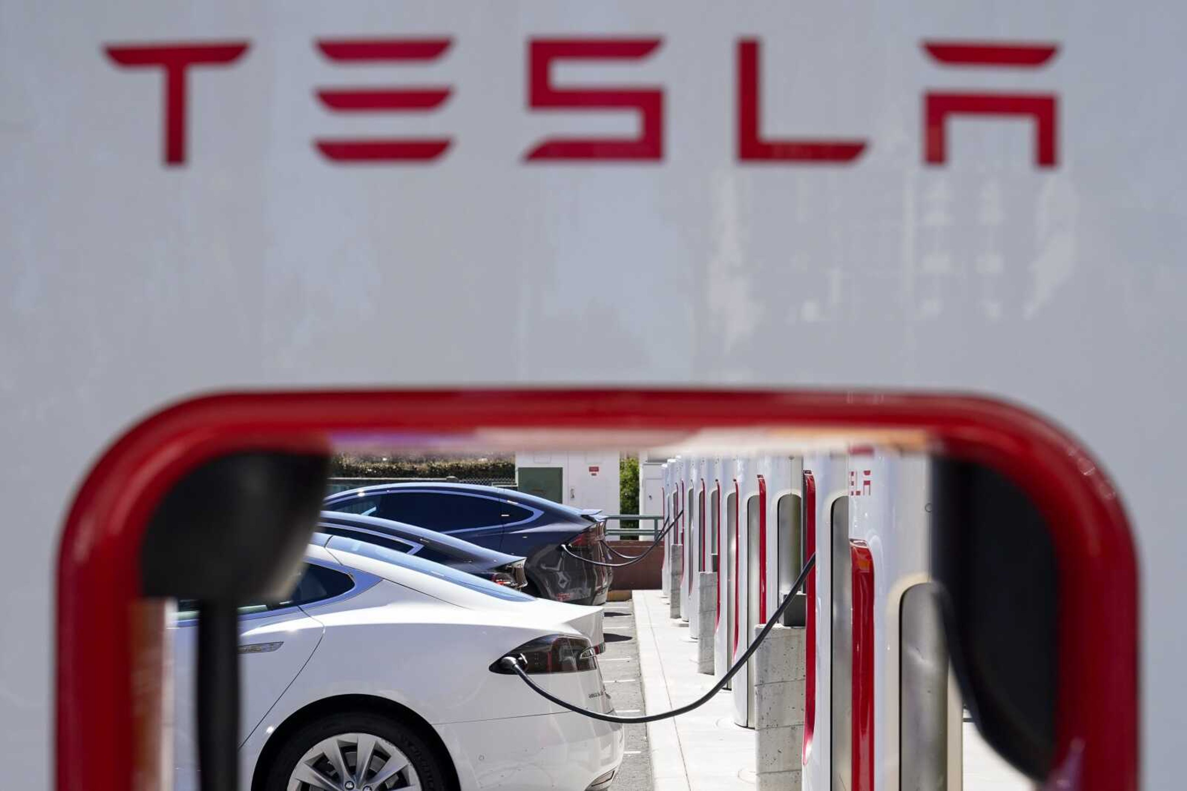 Tesla vehicles charge at a station Wednesday in Emeryville, California.