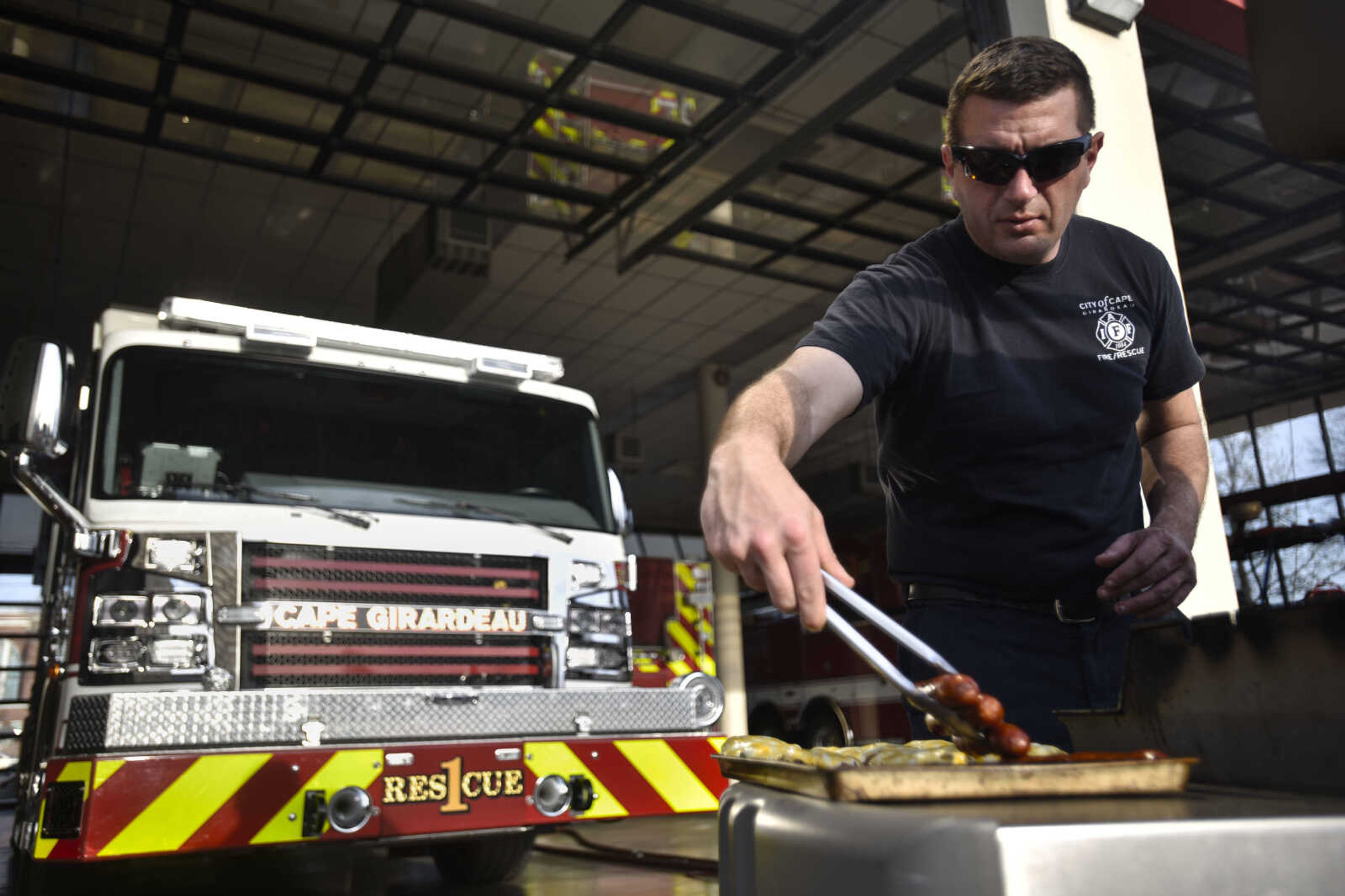 Cape Girardeau firefighter Drew Goodale takes bratwursts off the grill Tuesday, April 17, 2018, at Cape Girardeau Fire Station No. 1.