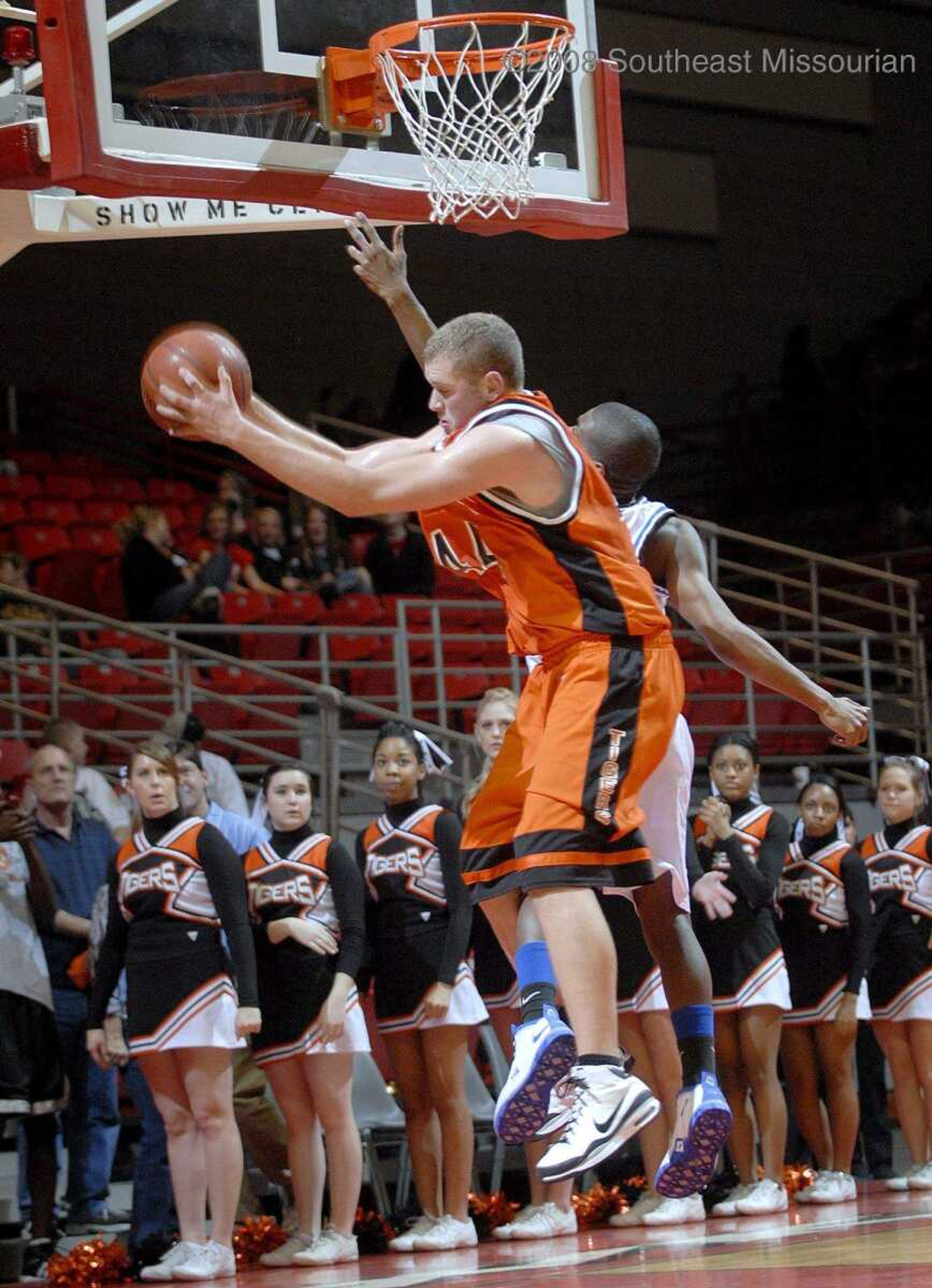 ELIZABETH DODD ~ edodd@semissourian.com
Cape Central's Zach Boerboom, left, grabs a rebound after blocking a shot by Charleston's Donald Dixon in the first half of the Christmas Tournament Saturday at the Show Me Center. Central lost to Charleston 51-42.