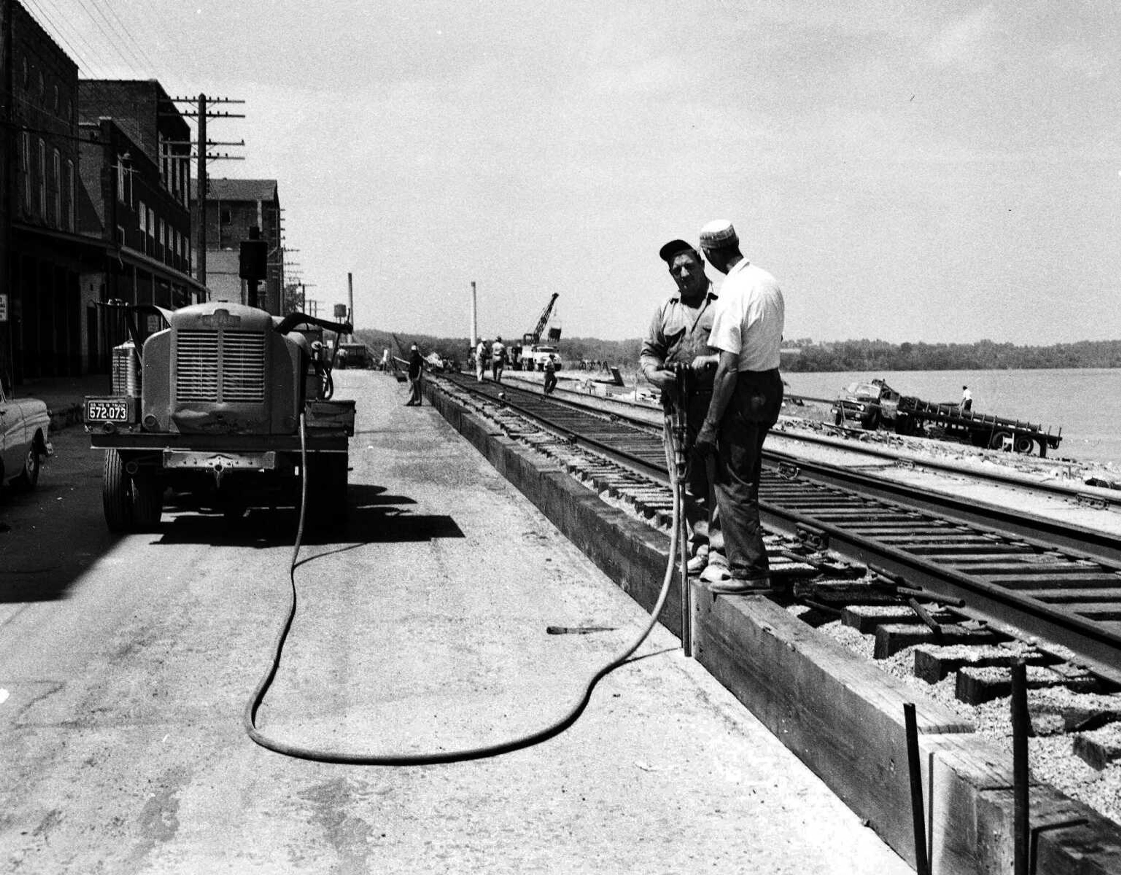 This photograph was taken on the riverfront, just south of Broadway. New railroad tracks were being laid on the east edge of Water street to provide more room for floodwall construction down the slope.