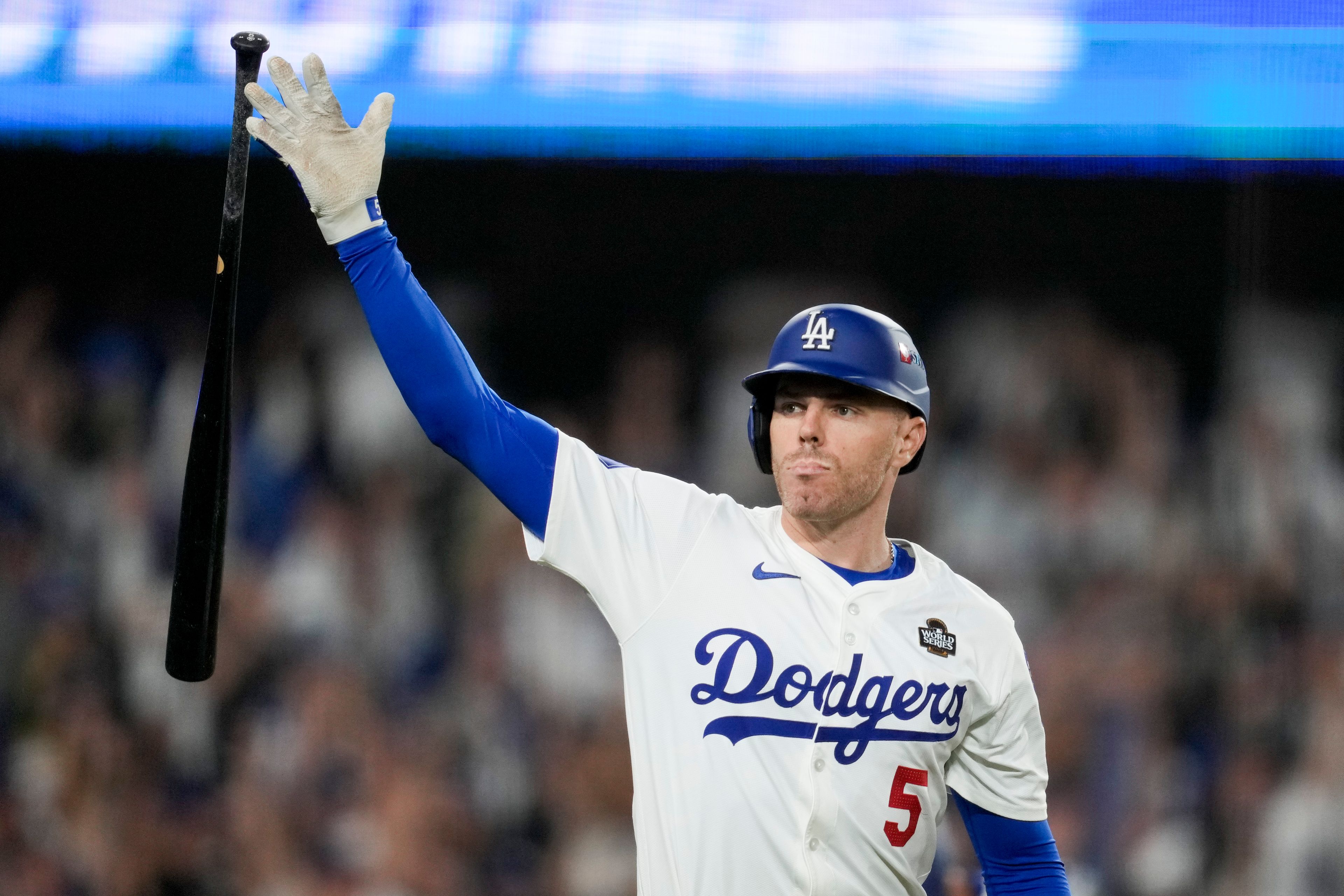 Los Angeles Dodgers' Freddie Freeman celebrates his walk-off grand slam home run against the New York Yankees during the 10th inning in Game 1 of the baseball World Series, Friday, Oct. 25, 2024, in Los Angeles. (AP Photo/Ashley Landis)