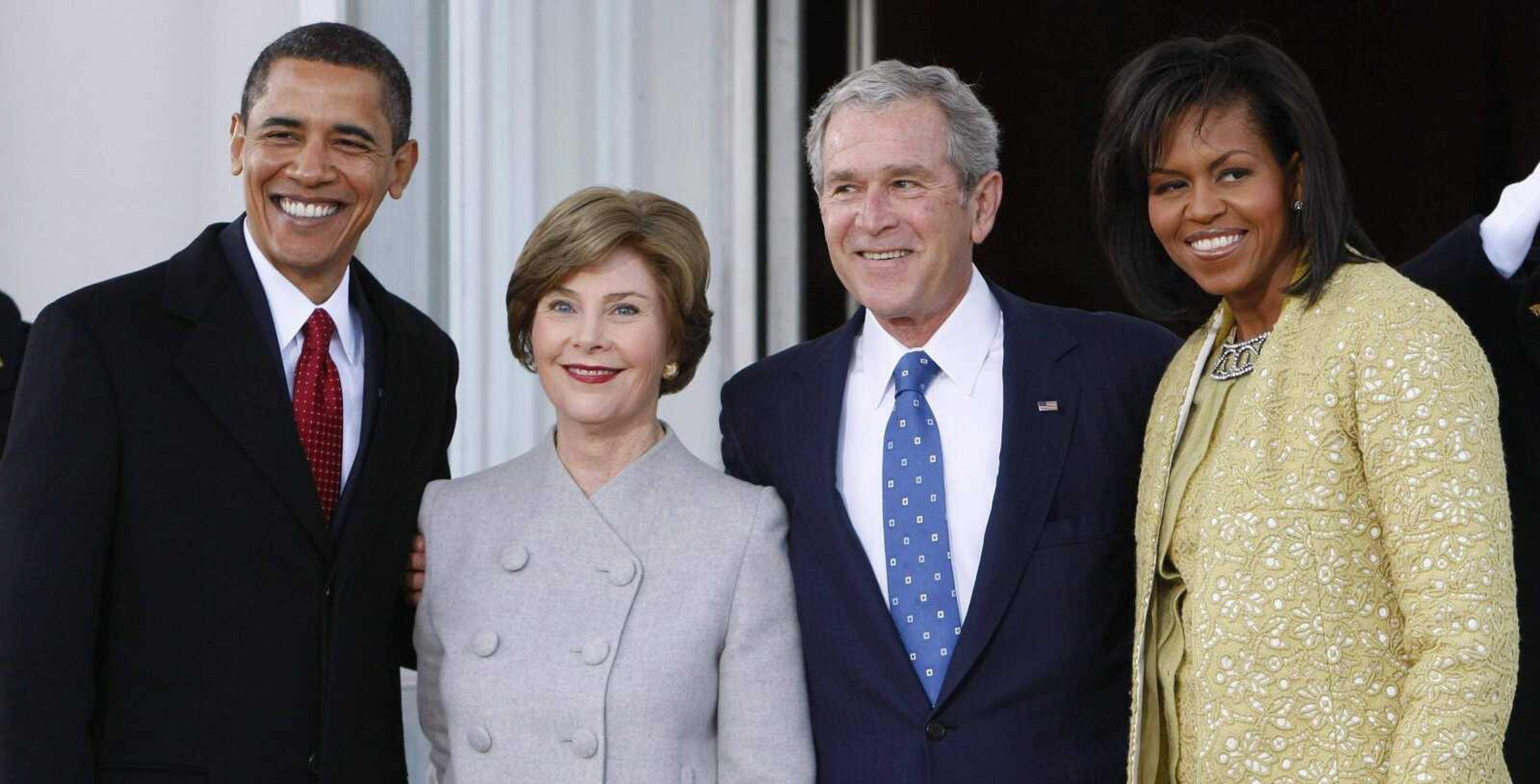 President Bush, center right, and first lady Laura Bush, center left, welcome President-elect Barack Obama, far left, and his wife Michelle Obama, right, on the North Portico of the White House in Washington, Tuesday, Jan. 20, 2009. (AP Photo/Pablo Martinez Monsivais)