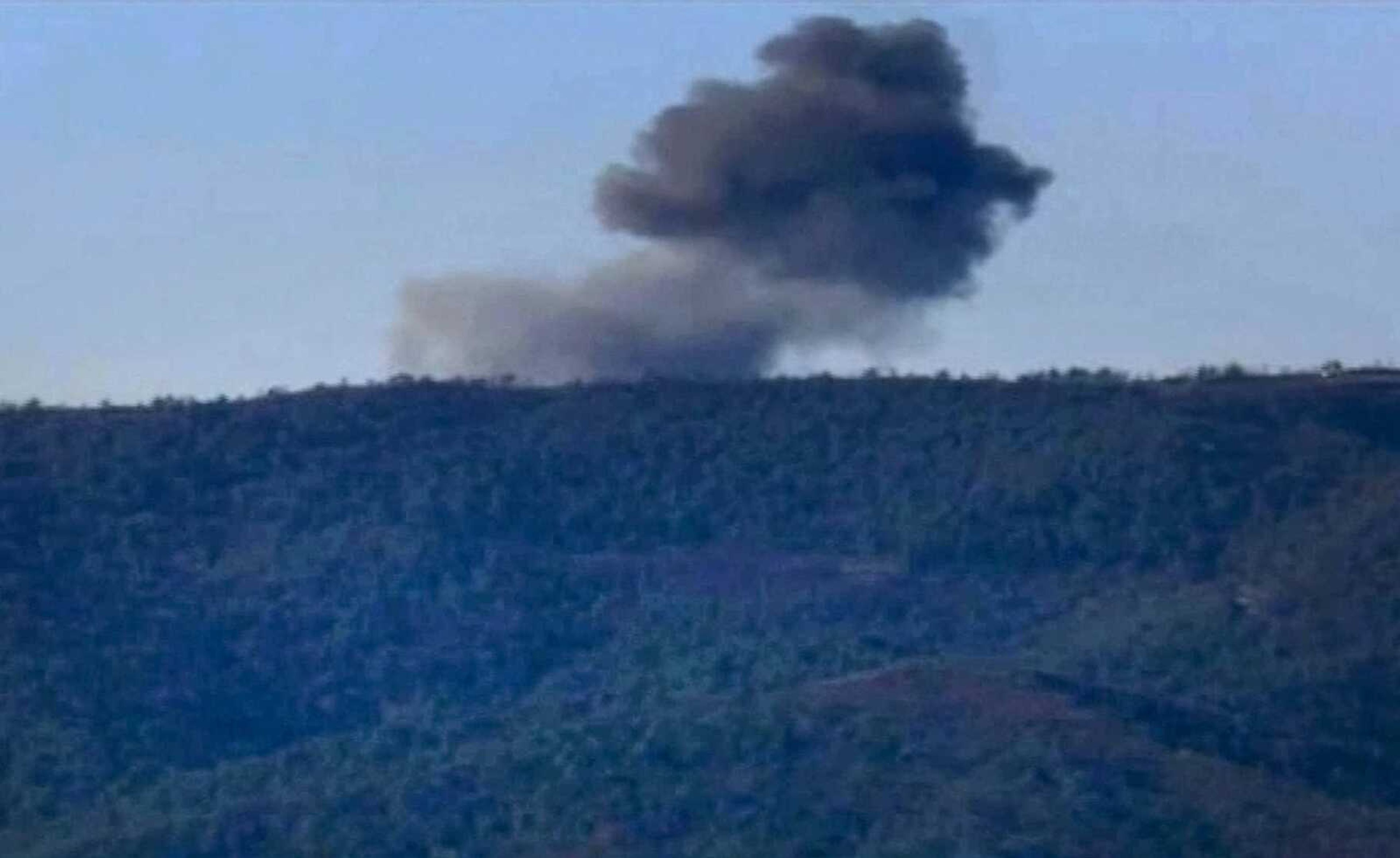 An image from video shows smoke from a Russian warplane after it crashed on a hill near Hatay province, Turkey. (Haberturk TV via AP)