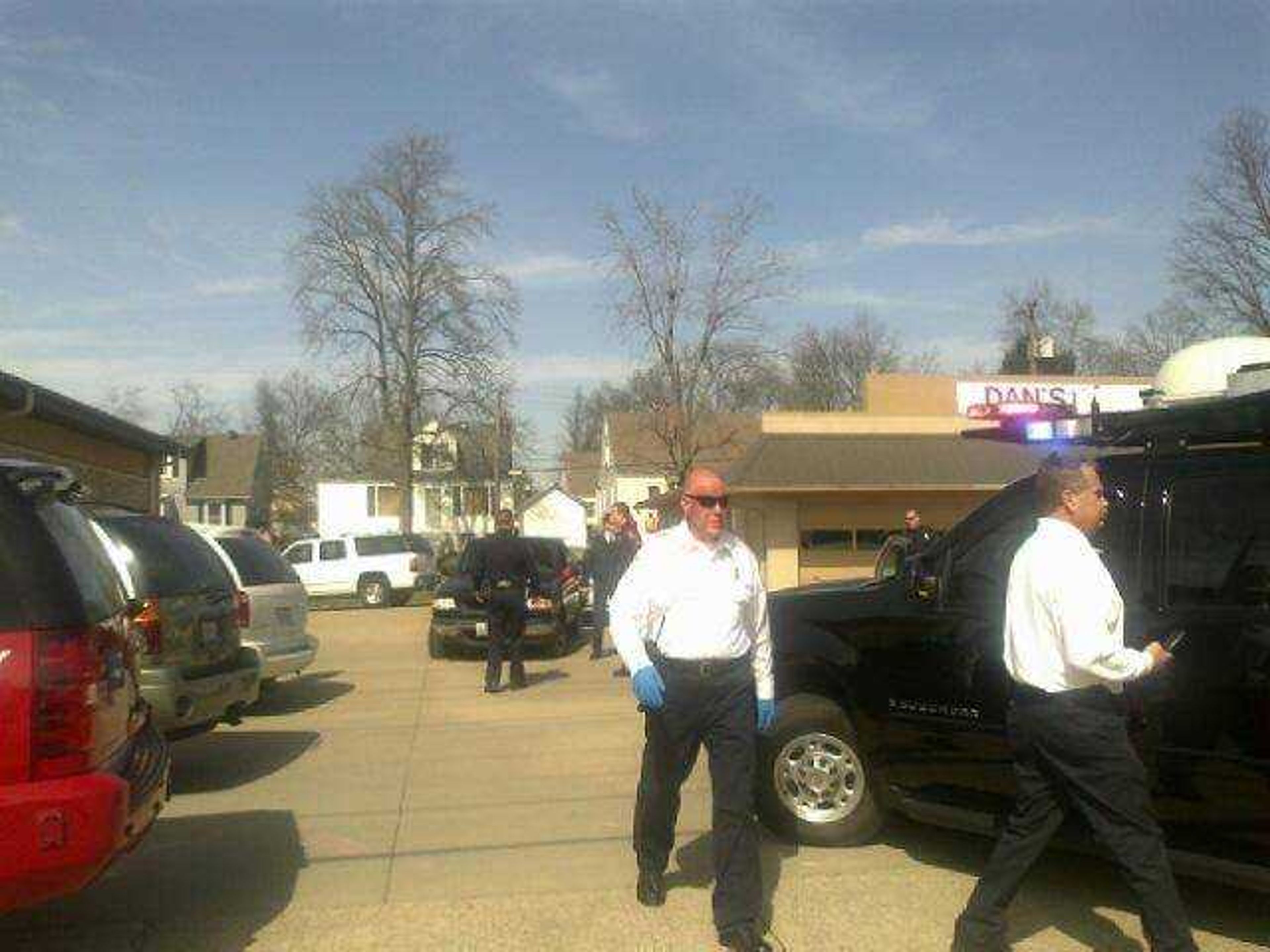 This cell phone camera picture shows police investigating the scene where a man suspected in a Sunday assault on a Cape Girardeau recreational trail shot himself Tuesday, March 6, 2012. (Erin Ragan)