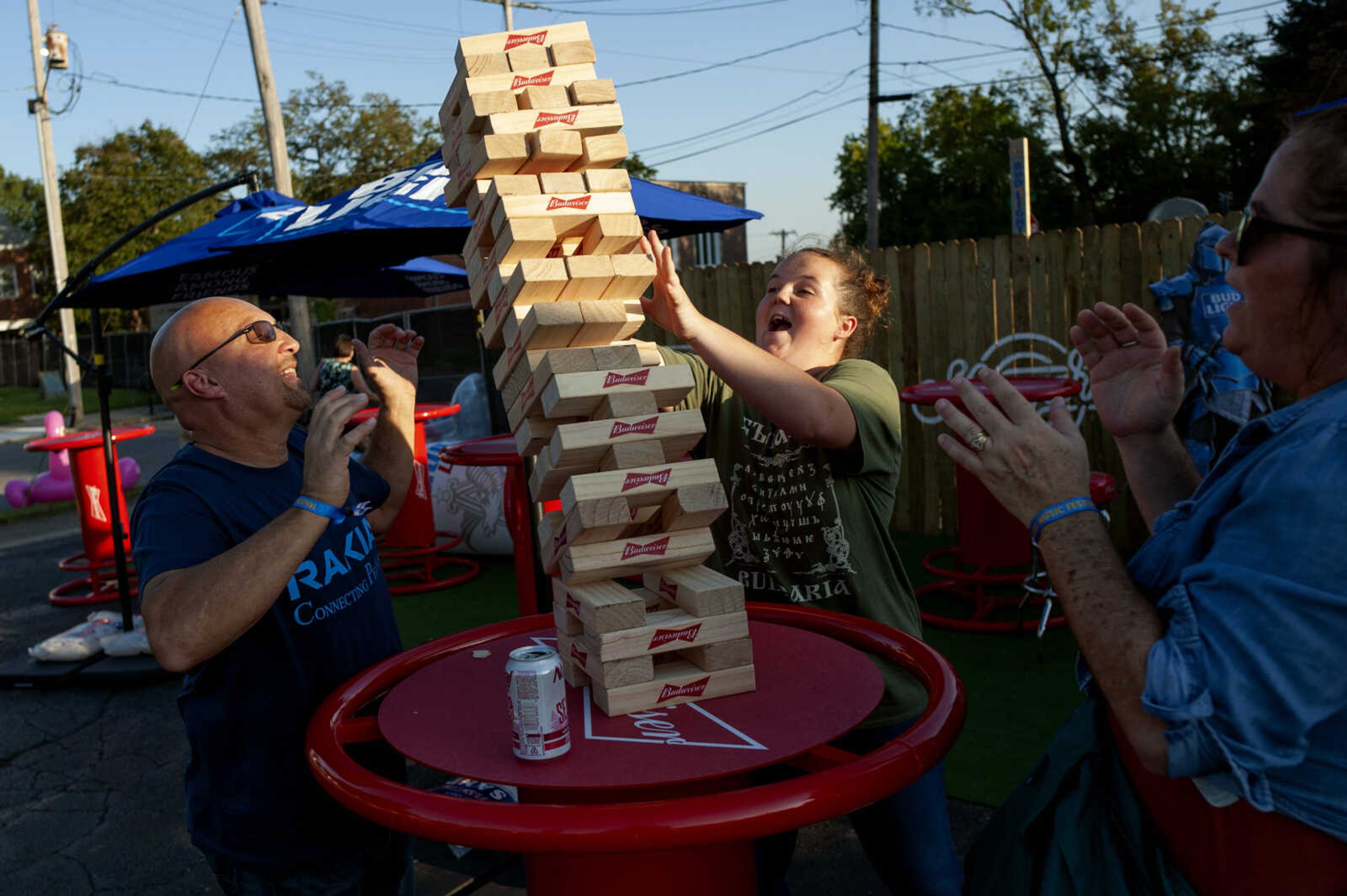 From left: Tim Proctor, Lizzy Proctor, 12, and Jenny Proctor, of Cape Girardeau, react to a falling tower during Shipyard Music and Culture Festival on Friday, Sept. 27, 2019, in Cape Girardeau.