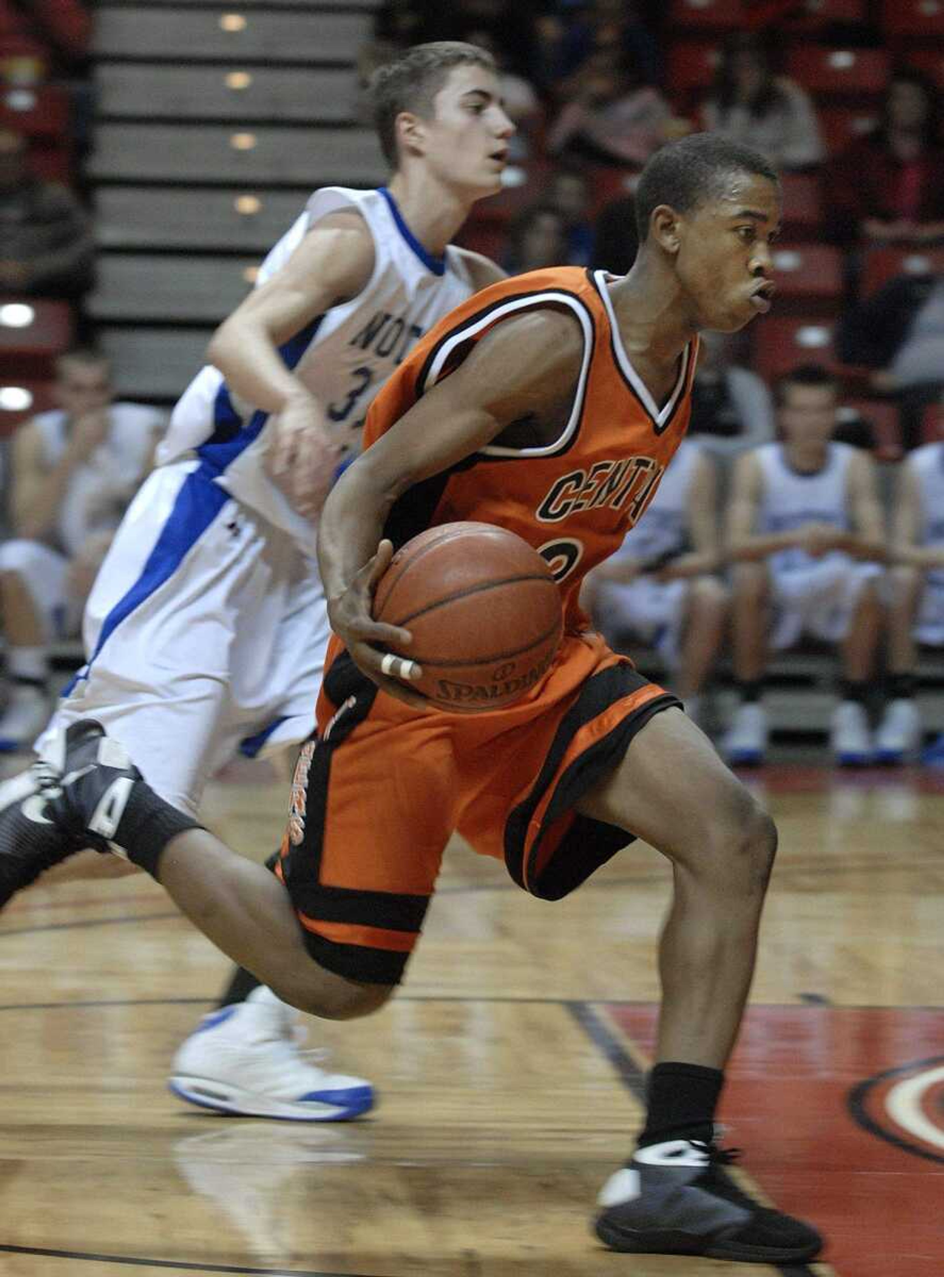 FRED LYNCH ~ flynch@semissourian.com
Central's Josh Harris drive away from Notre Dame's Jacob Tolbert in the first quarter Monday at the Show Me Center.