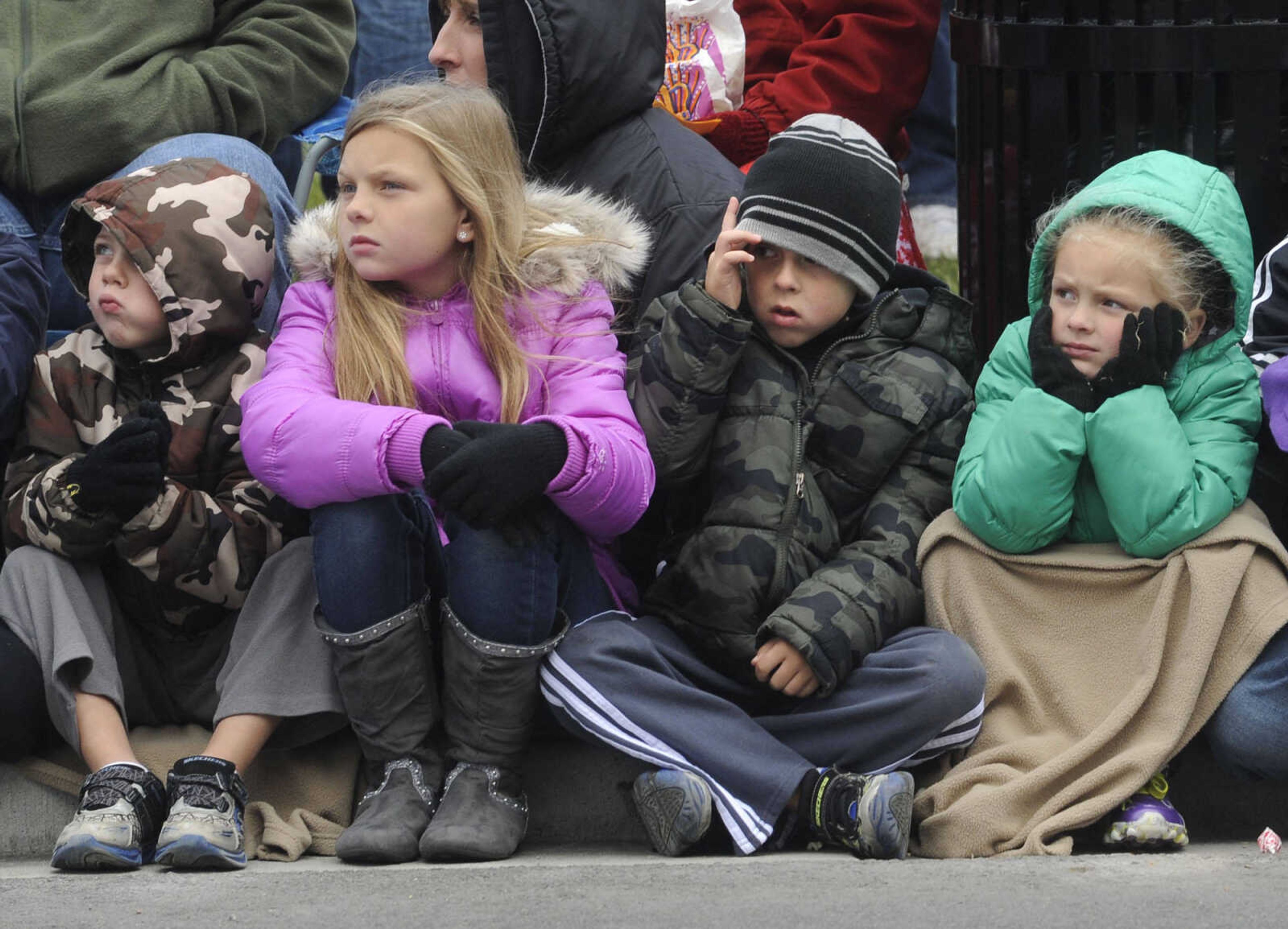 Children sit along the route of the SEMO Homecoming parade Saturday, Oct. 26, 2013 on Broadway in Cape Girardeau.