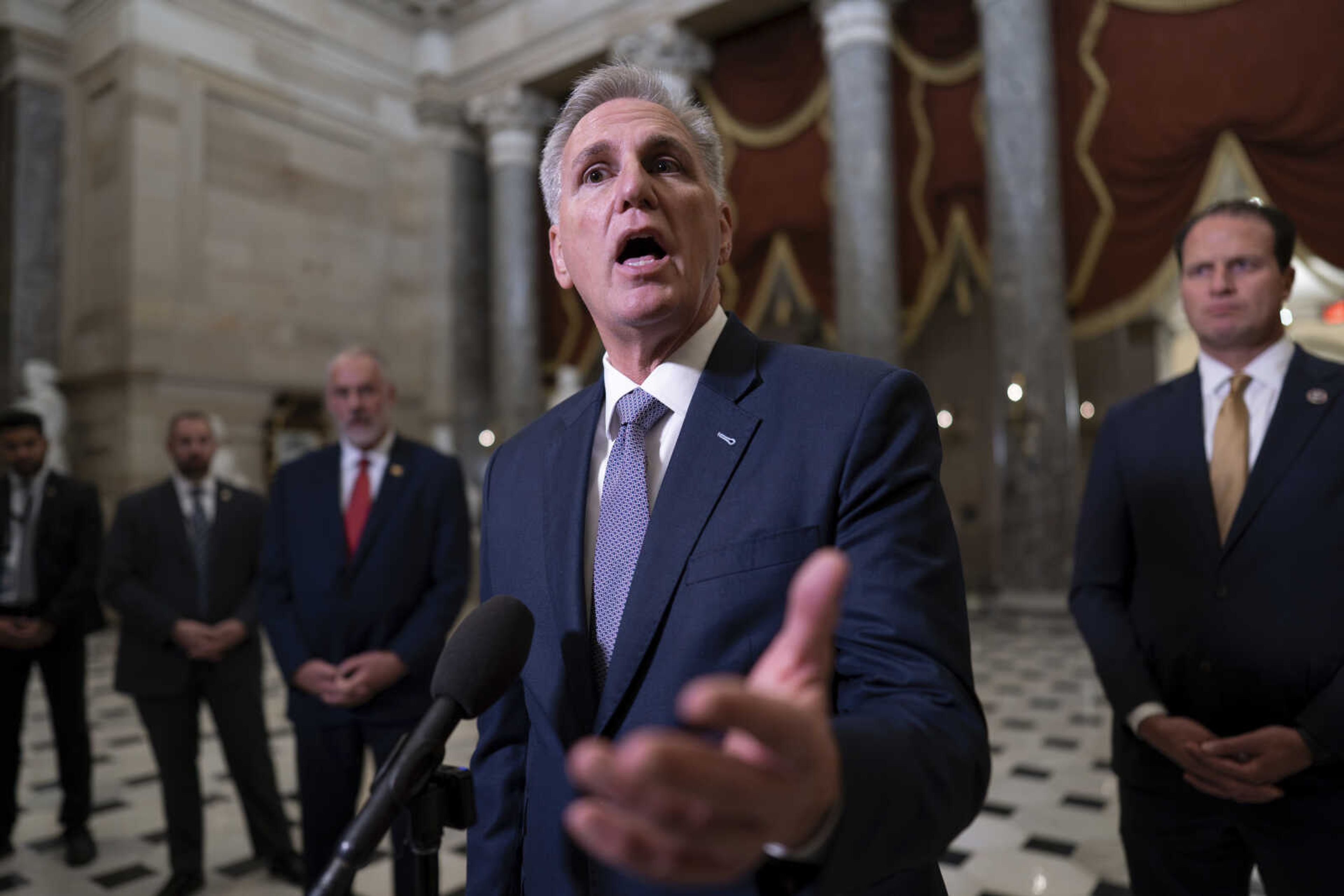 House Speaker Kevin McCarthy, R-Calif., joined by fellow Republicans, talks to reporters Tuesday night just after voting to advance appropriations bills on the House floor, at the Capitol in Washington.