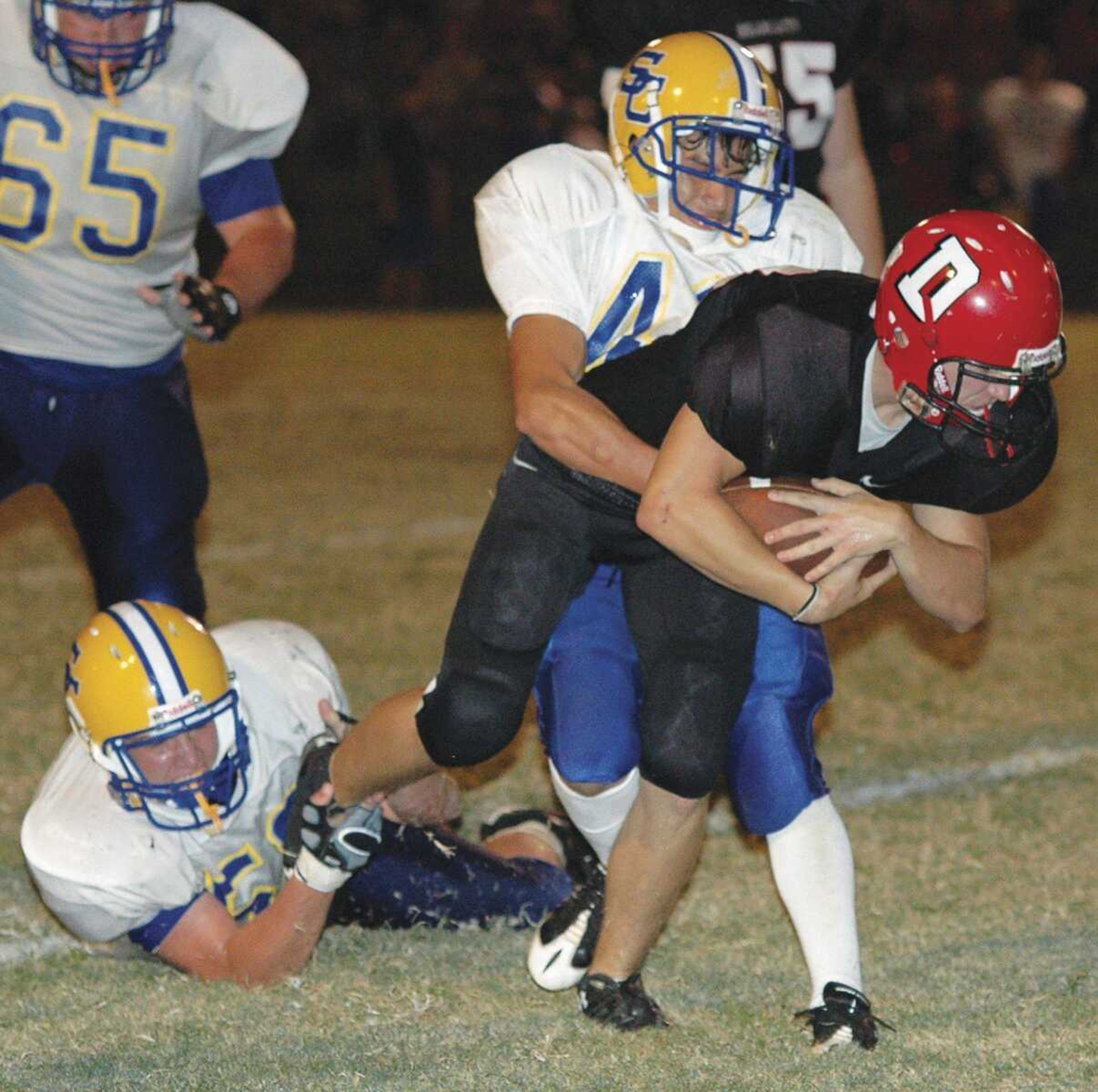 Scott City sophomore Logan Farmer hauls down Dexter runner Dylan Baggett during Friday's game in Dexter, Mo. (JERRY JARRELL ~ Dexter Daily Statesman)