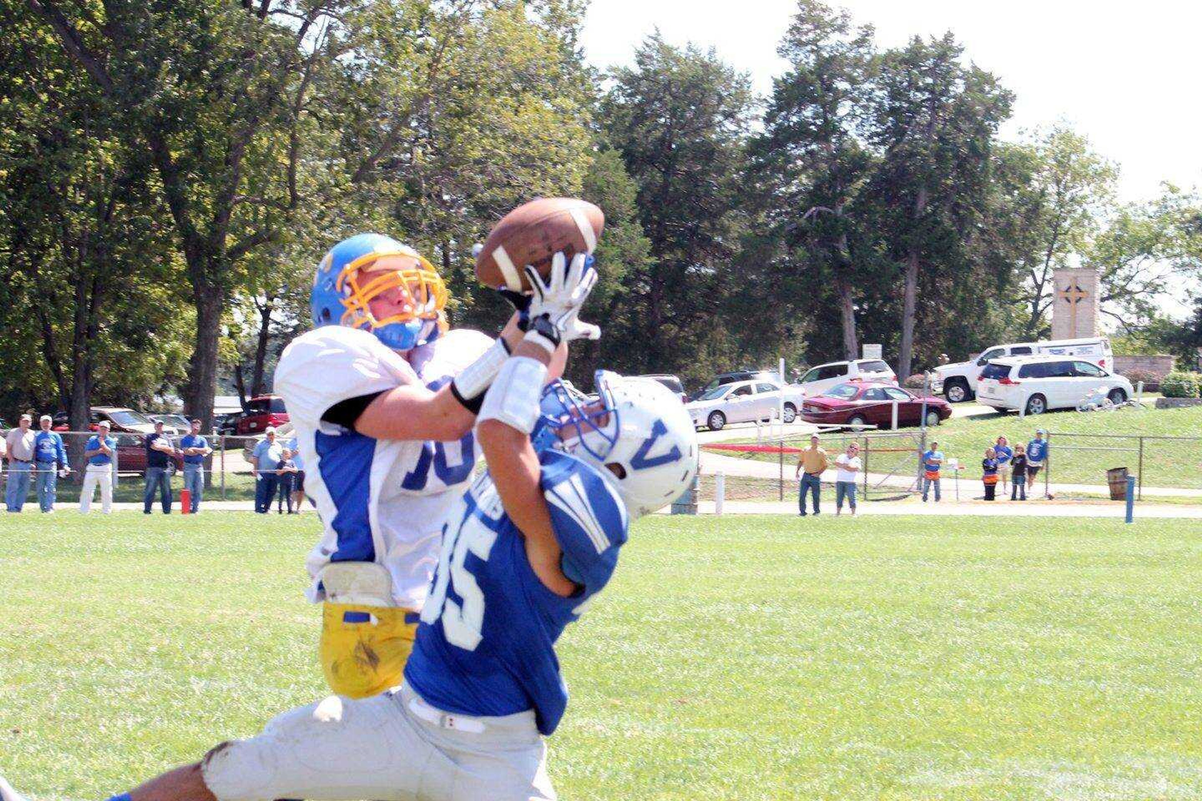 St. Vincent defensive back Jesse Francis, left, intercepts a pass intended for Valle Catholic receiver Trevor Klump during the third quarter Saturday.