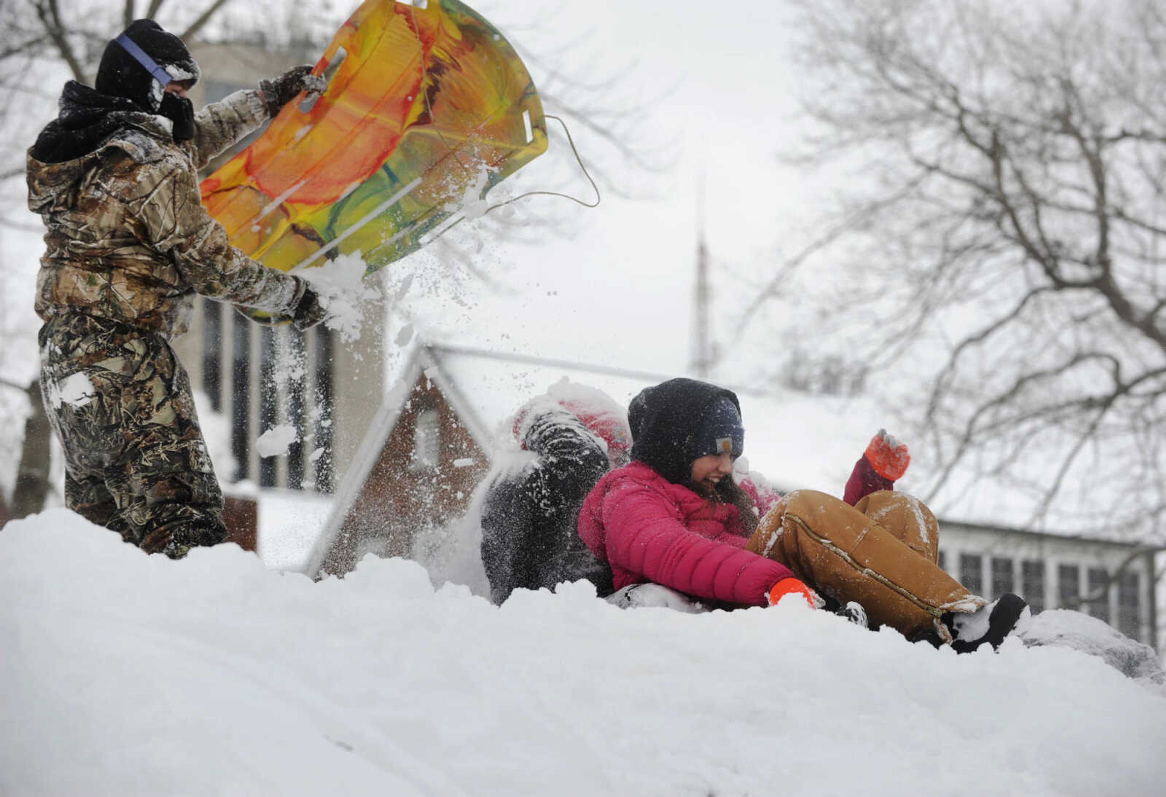 LAURA SIMON ~ lsimon@semissourian.com

Justin Emmendorfer dumps a load of snow on Hannah Lynn, center, and Kat Wallhausen, Monday, Feb. 16, 2015, in Cape Girardeau.