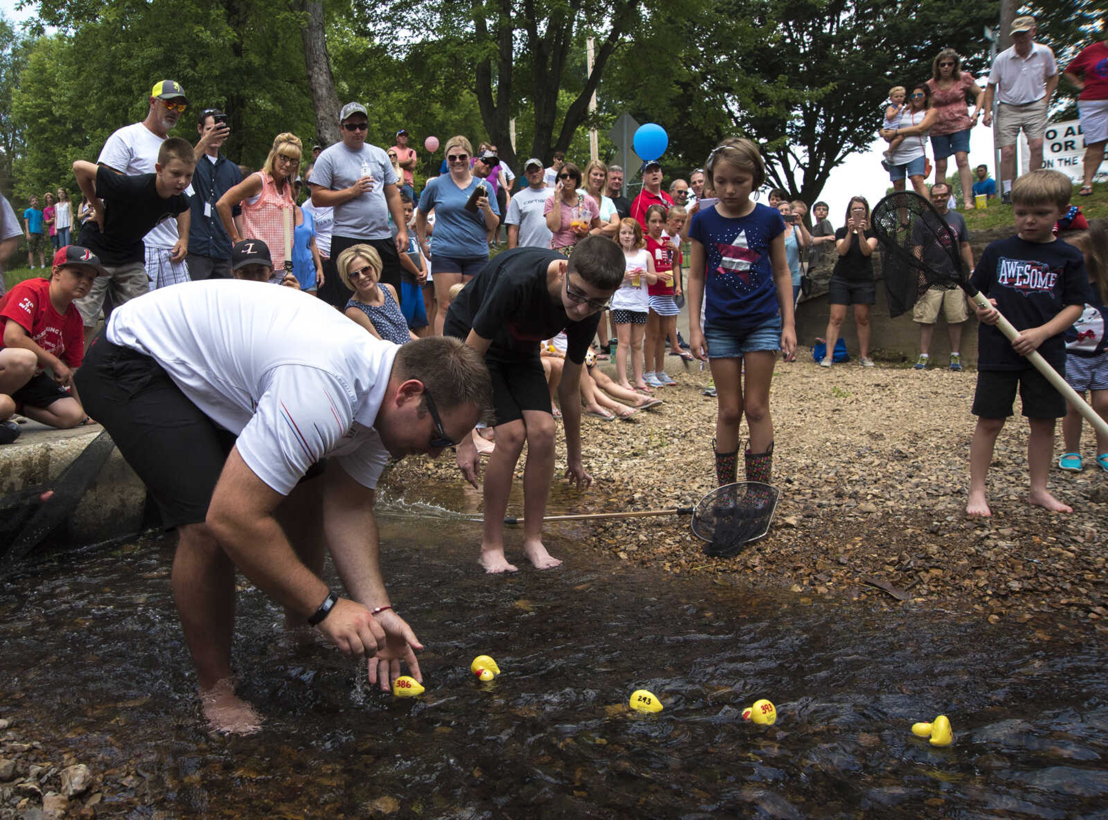 Ronnie Maxwell picks up rubber ducks after racing for the Jackson Parks and Recreation's July 4th celebration Tuesday, July 4, 2017 in Jackson City Park.