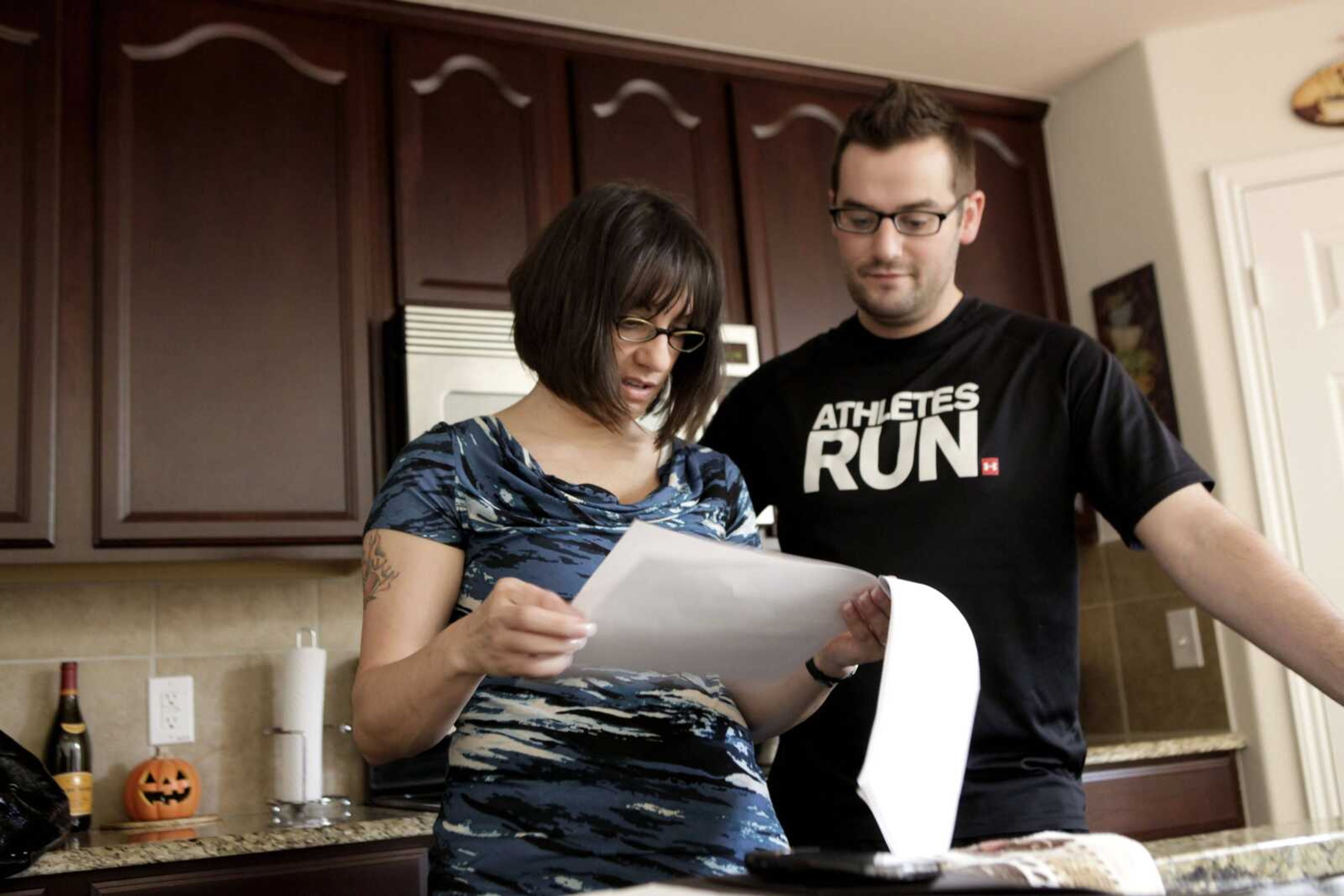 In this Nov. 10, 2010 photo, Gina Marie Haynes, left, looks over documents with her boyfriend Shawn Hicks before she heads to a job interview in Frisco, Texas. Haynes had just moved from Philadelphia to Texas with her boyfriend in August 2010 and lined up a job managing apartments. A background check found fraud charges, and Haynes lost the offer. (Associated Press file)