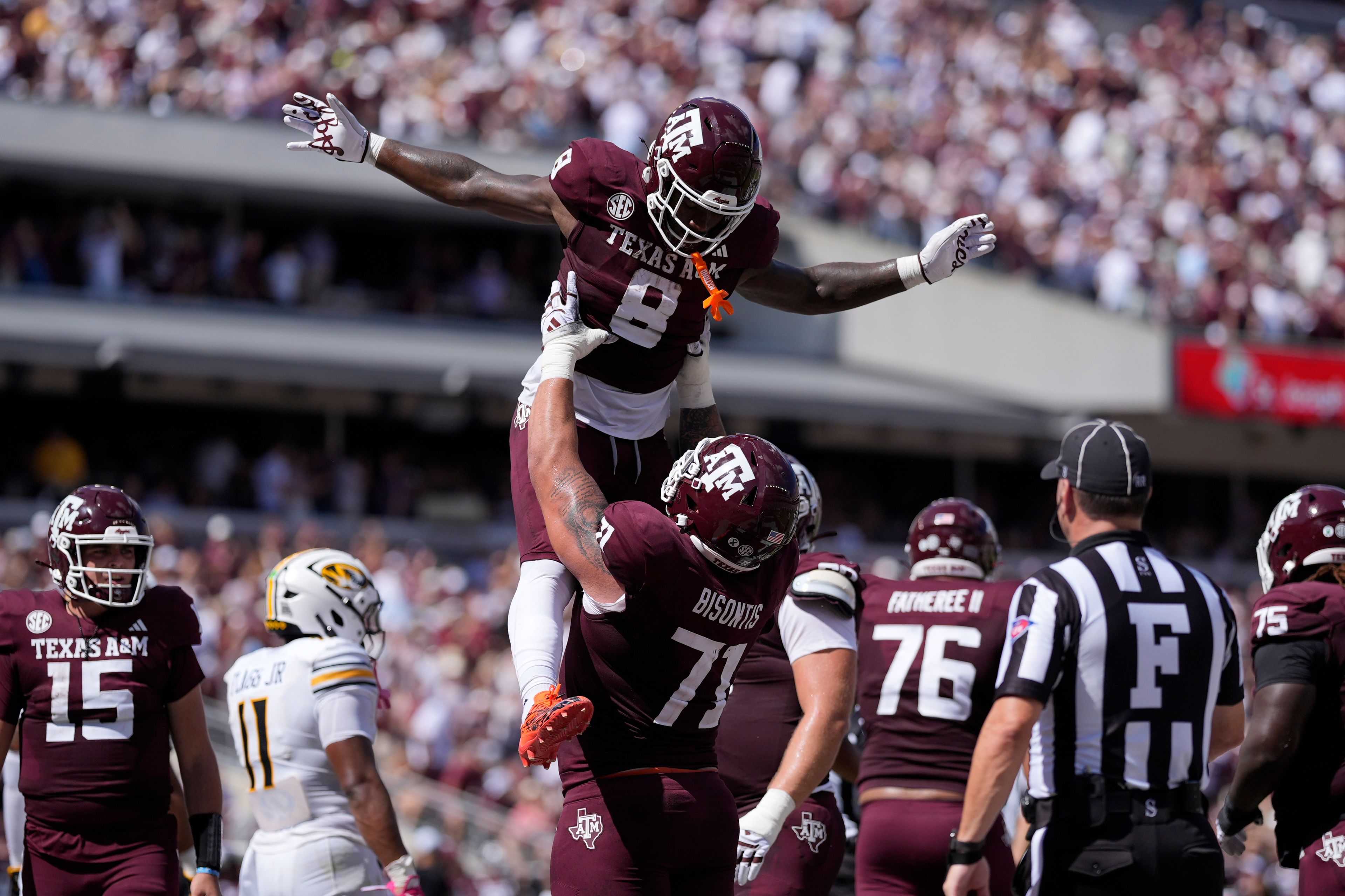 Texas A&M running back Le'Veon Moss (8) celebrates with teammate Chase Bisontis (71) after he scored a touchdown against Missouri during the first half of an NCAA college football game Saturday, Oct. 5, 2024, in College Station, Texas. (AP Photo/Eric Gay)