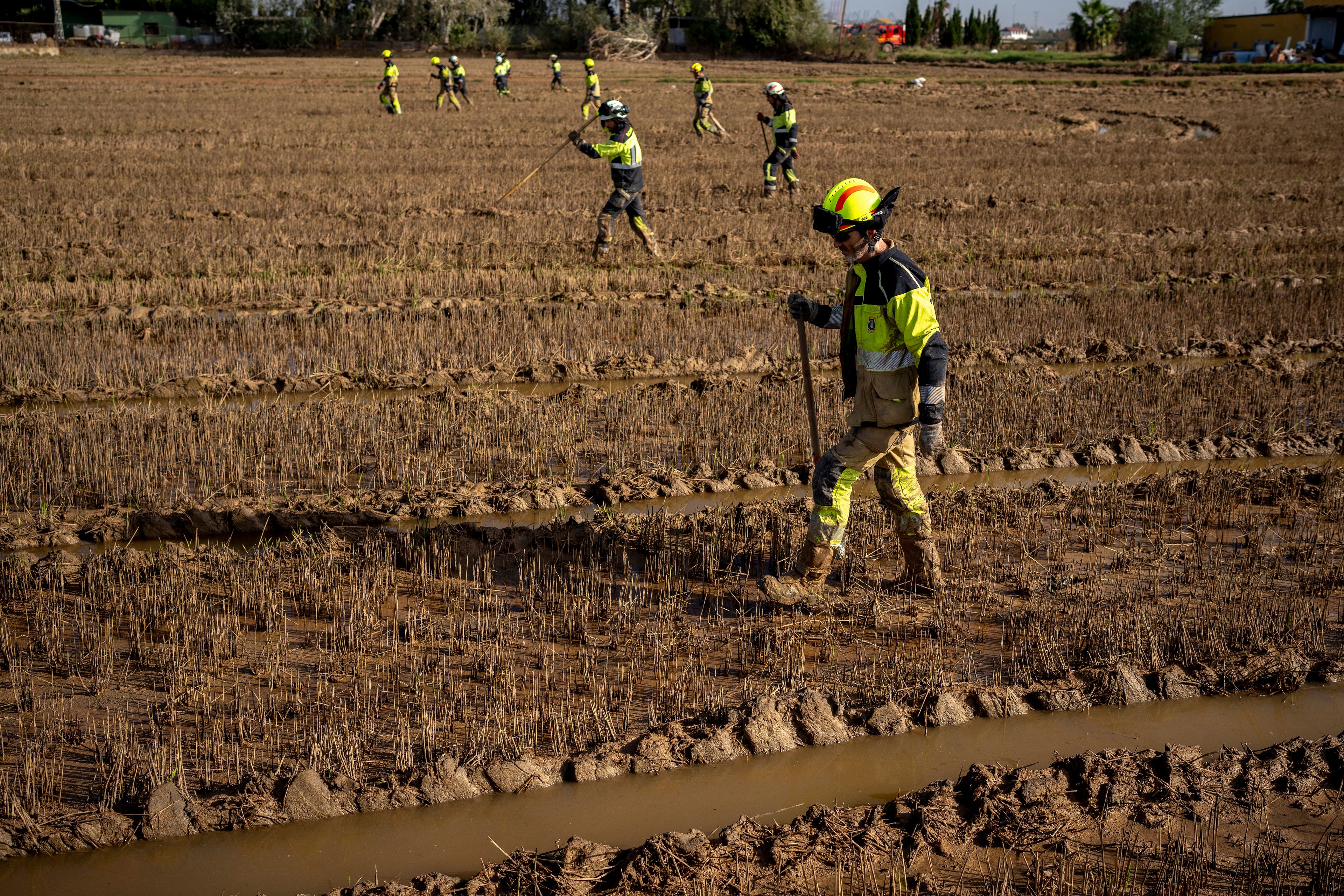 Members of the fire brigade search the area for bodies washed away by the floods in the outskirts of Valencia, Spain, Friday, Nov. 8, 2024. (AP Photo/Emilio Morenatti)