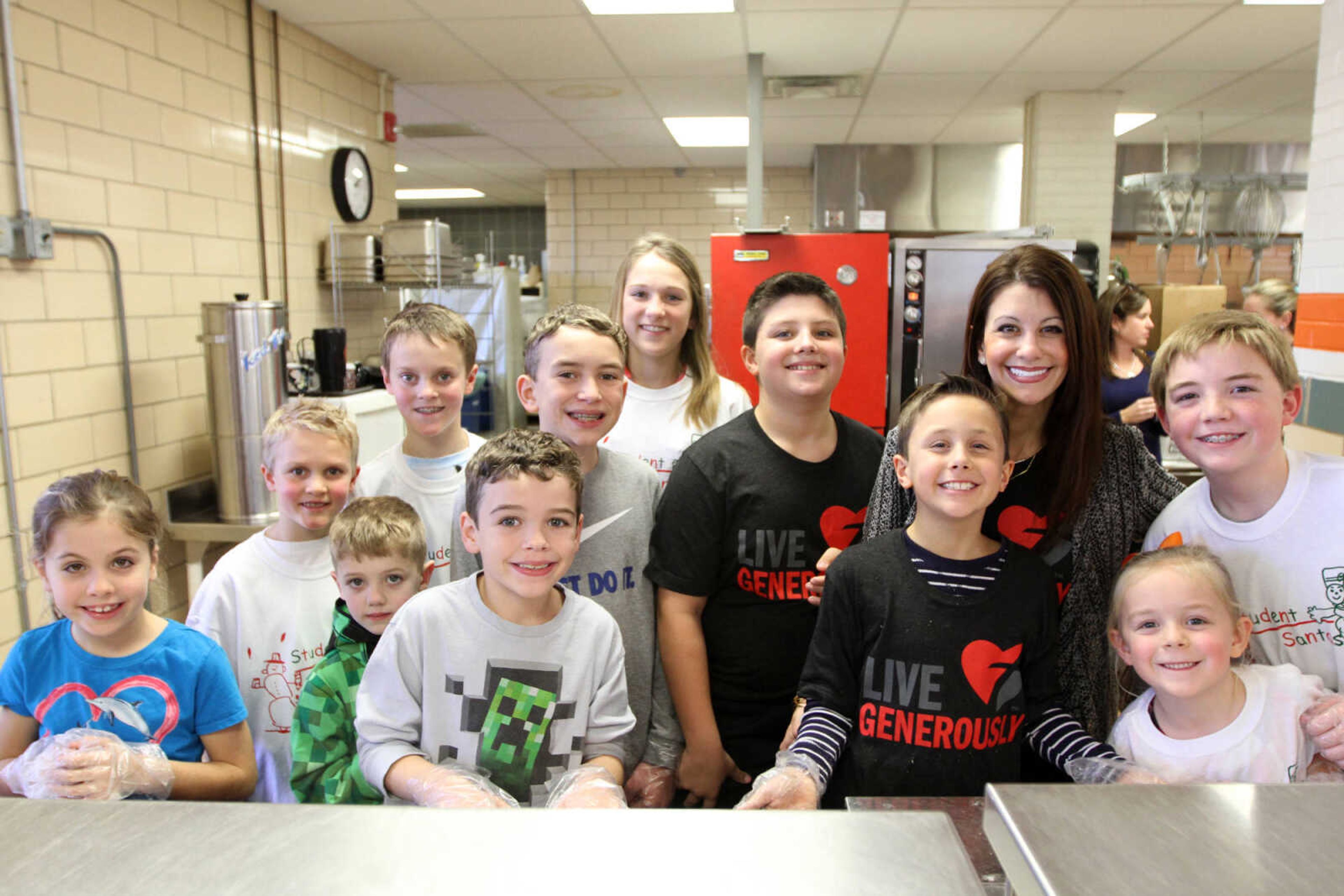 GLENN LANDBERG ~ glandberg@semissourian.com

A group of volunteers pose for a photo during the Student Santas Christmas dinner Thursday, Dec. 25, 2014 at Central Junior High School.