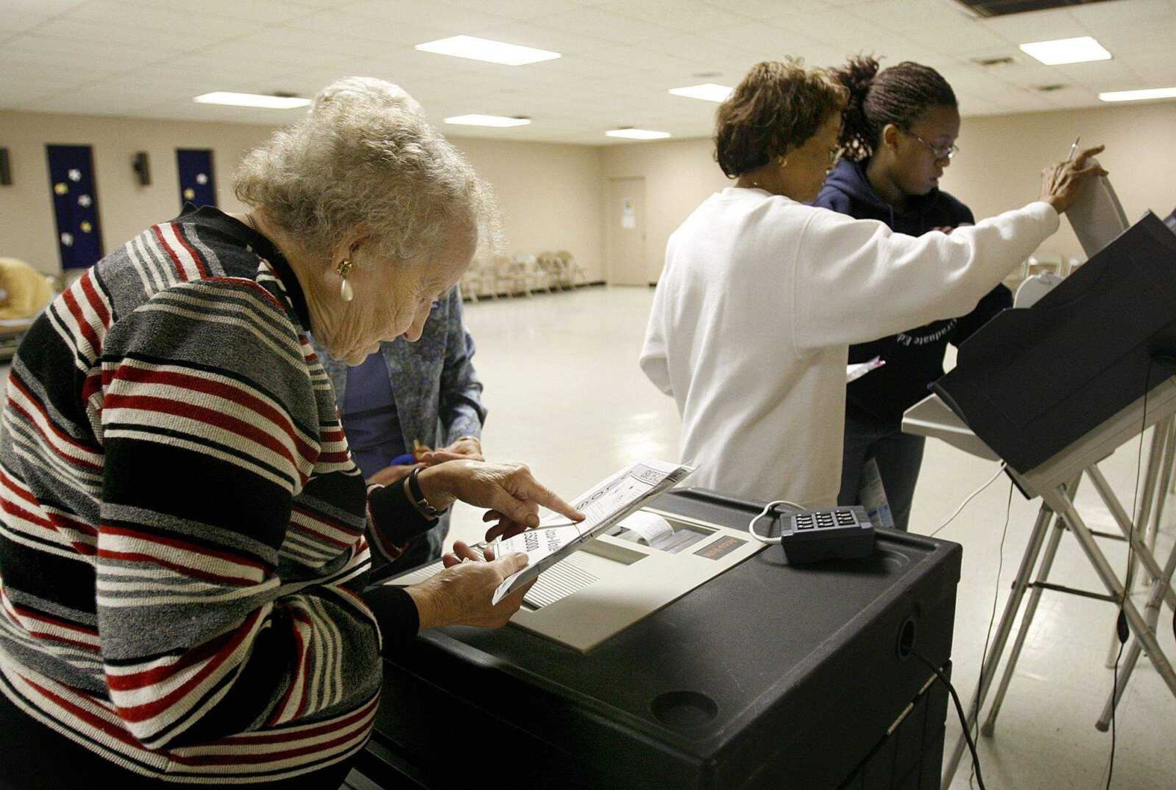 ELIZABETH DODD ~ edodd@semissourian.com
Election volunteers Helen Perry, left, Edna Newvern, and Kopper Thatch, all from Cape Girardeau, close down the machines at Red Star Baptist Church after the polls closed Tuesday.