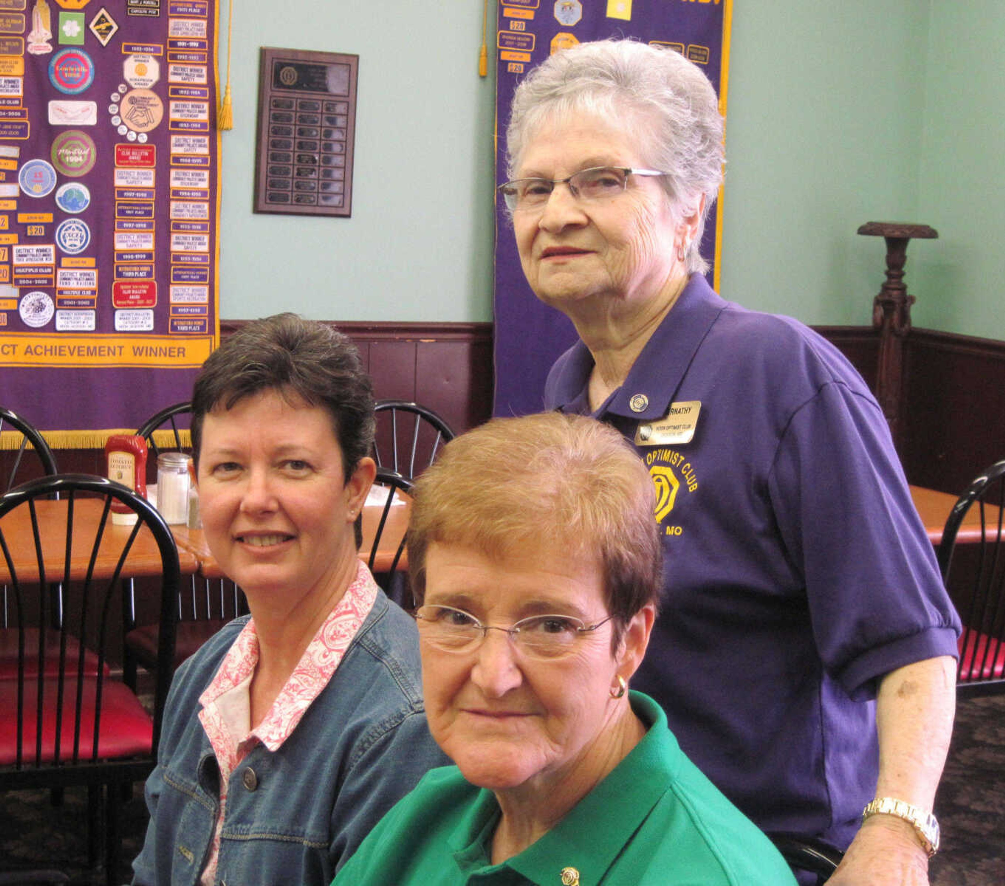 Lesa Weiss, Carol Rohlfs and Pat Abernathy, standing