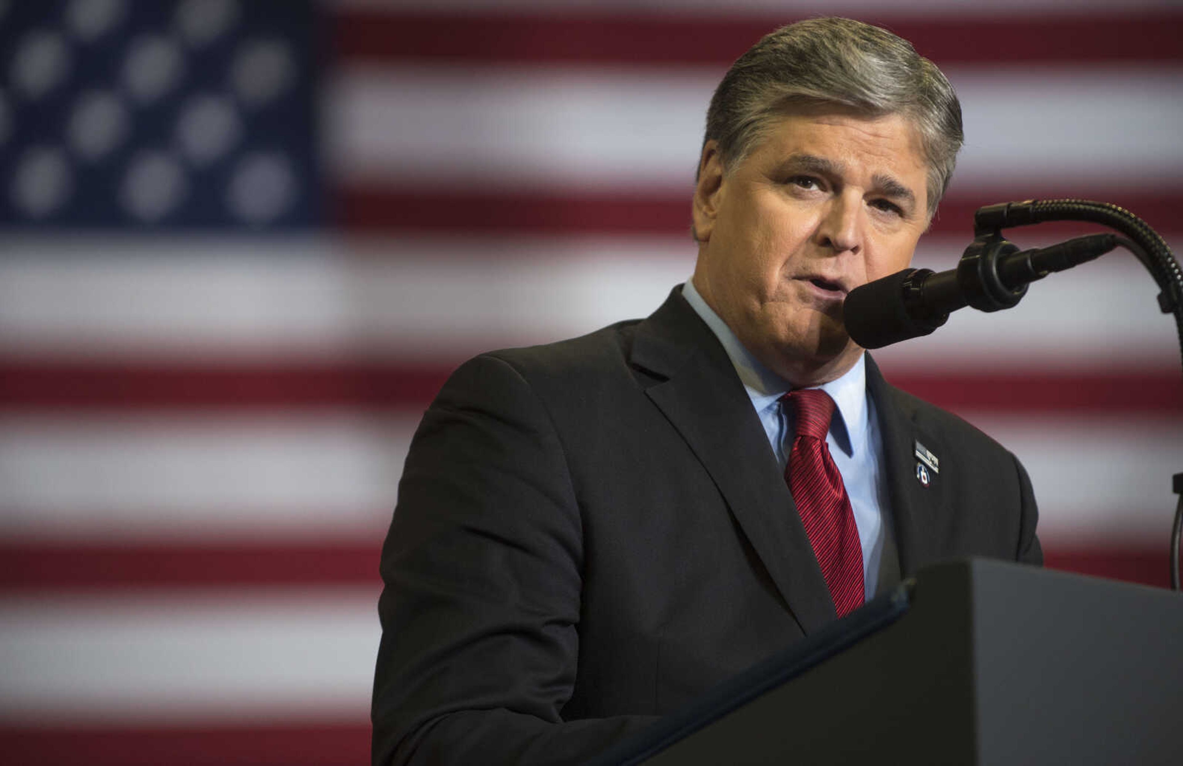 Sean Hannity speaks at the podium during a Make America Great Again rally Monday, Nov. 5, 2018, at the Show Me Center.