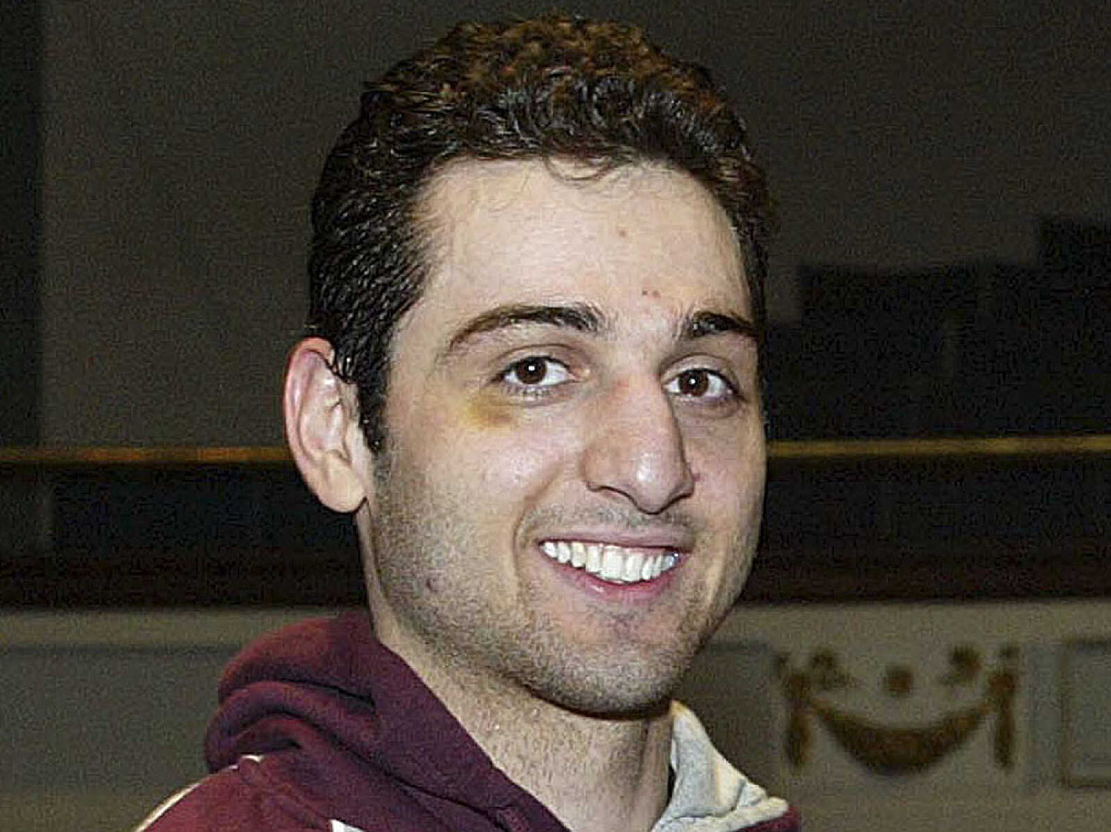 FILE - In this Feb. 17, 2010, photo, Tamerlan Tsarnaev smiles after accepting the trophy for winning the 2010 New England Golden Gloves Championship in Lowell, Mass. Tsarnaev, the Boston Marathon bombing suspect killed in a police shootout, was buried in an undisclosed location outside the city of Worcester, police said Thursday, May 9, 2013.  (AP Photo/The Lowell Sun, Julia Malakie, File)