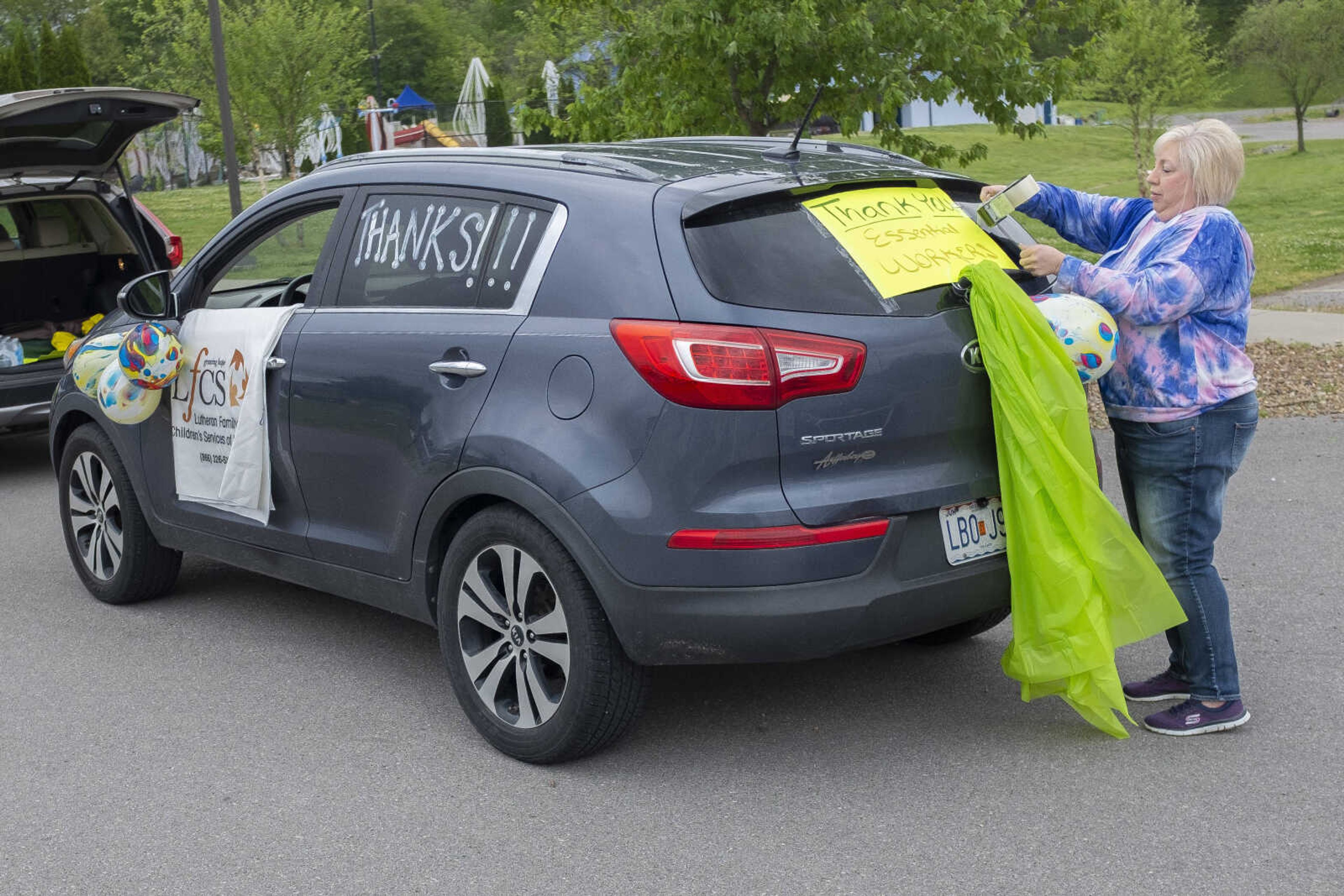 Christy O'Neal, a development officer with Lutheran Family and Children's Services of Missouri, gets a vehicle ready before the start of the United Way of Southeast Missouri's #GiveUnitedCarParade on Tuesday, May 5, 2020, at the Osage Centre in Cape Girardeau.